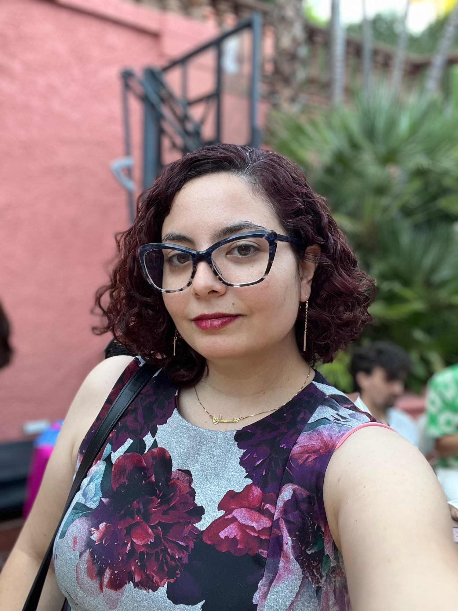 Selfie of me. I’m got curly reddish brown hair cut chin length. I’m wearing a cute sleeveless dress with dark red flowers on it. I look great for the record