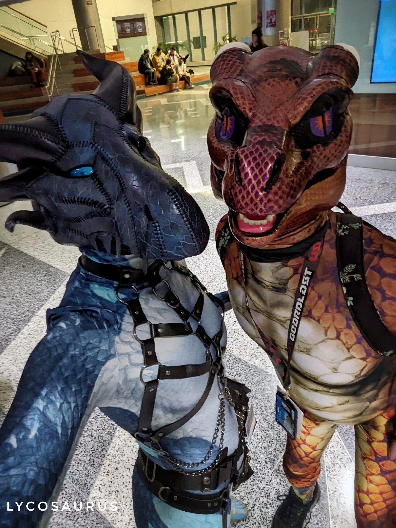 Selfie photo, two friends wearing scaly dragon masks & spandex bodysuits