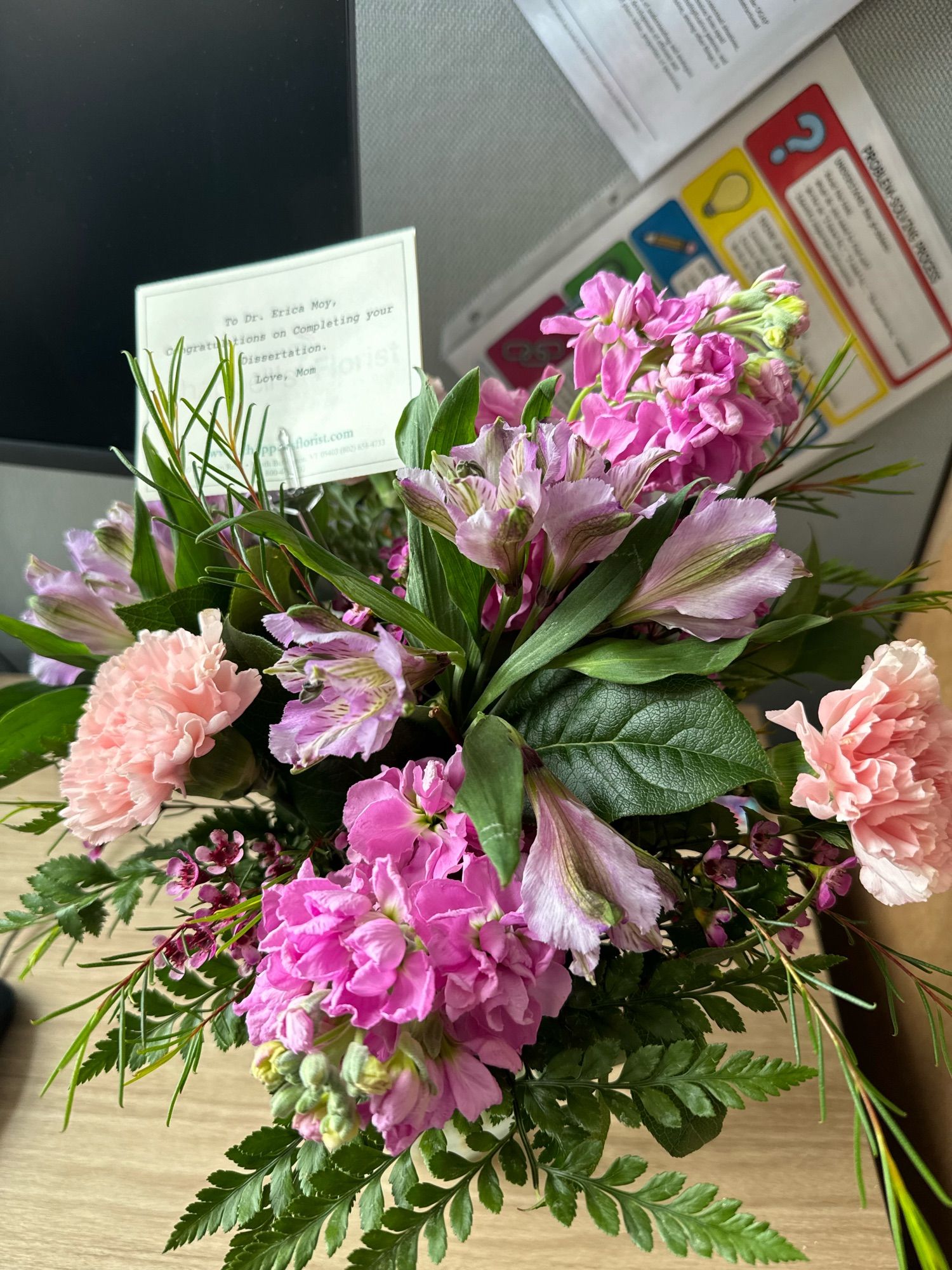 Mixture of pink and purple flowers and greenery