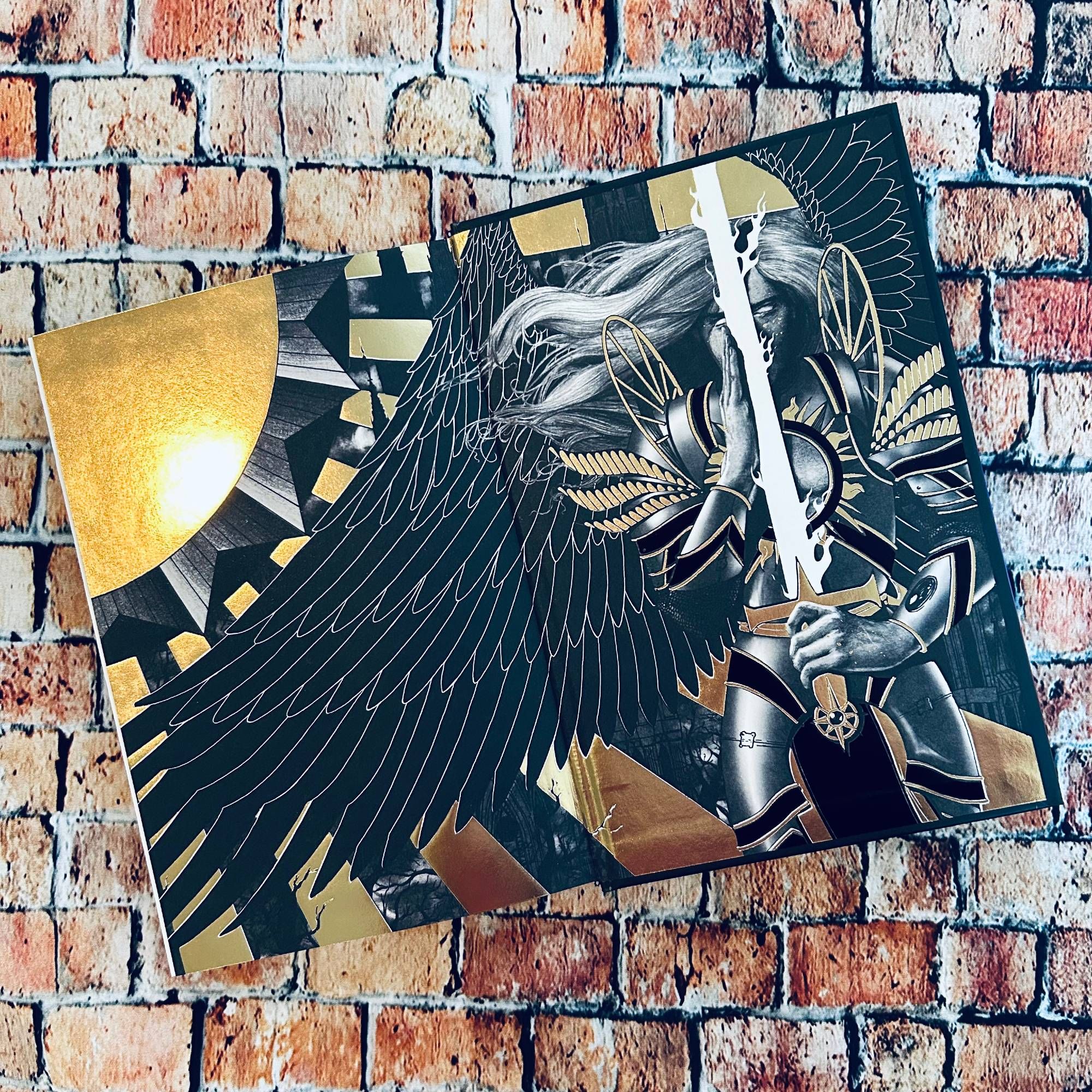 Close up of the back endpapers of Danya in angelic armor under the sun; the illustration is black and white with gold foiling.