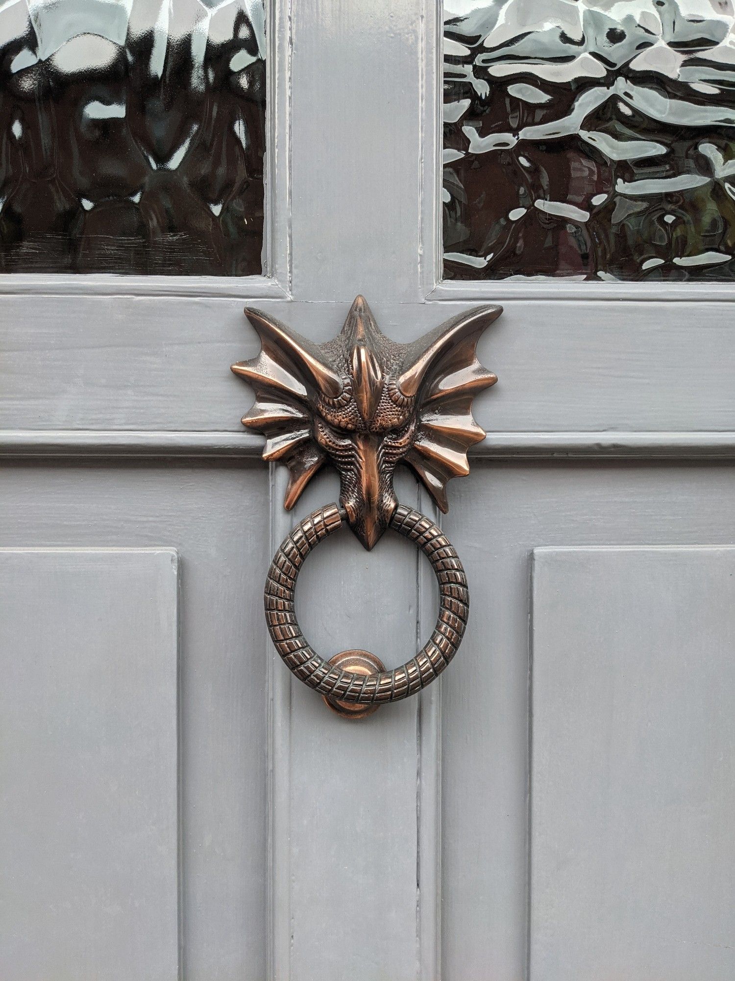 A door knocker shaped like a dragon head