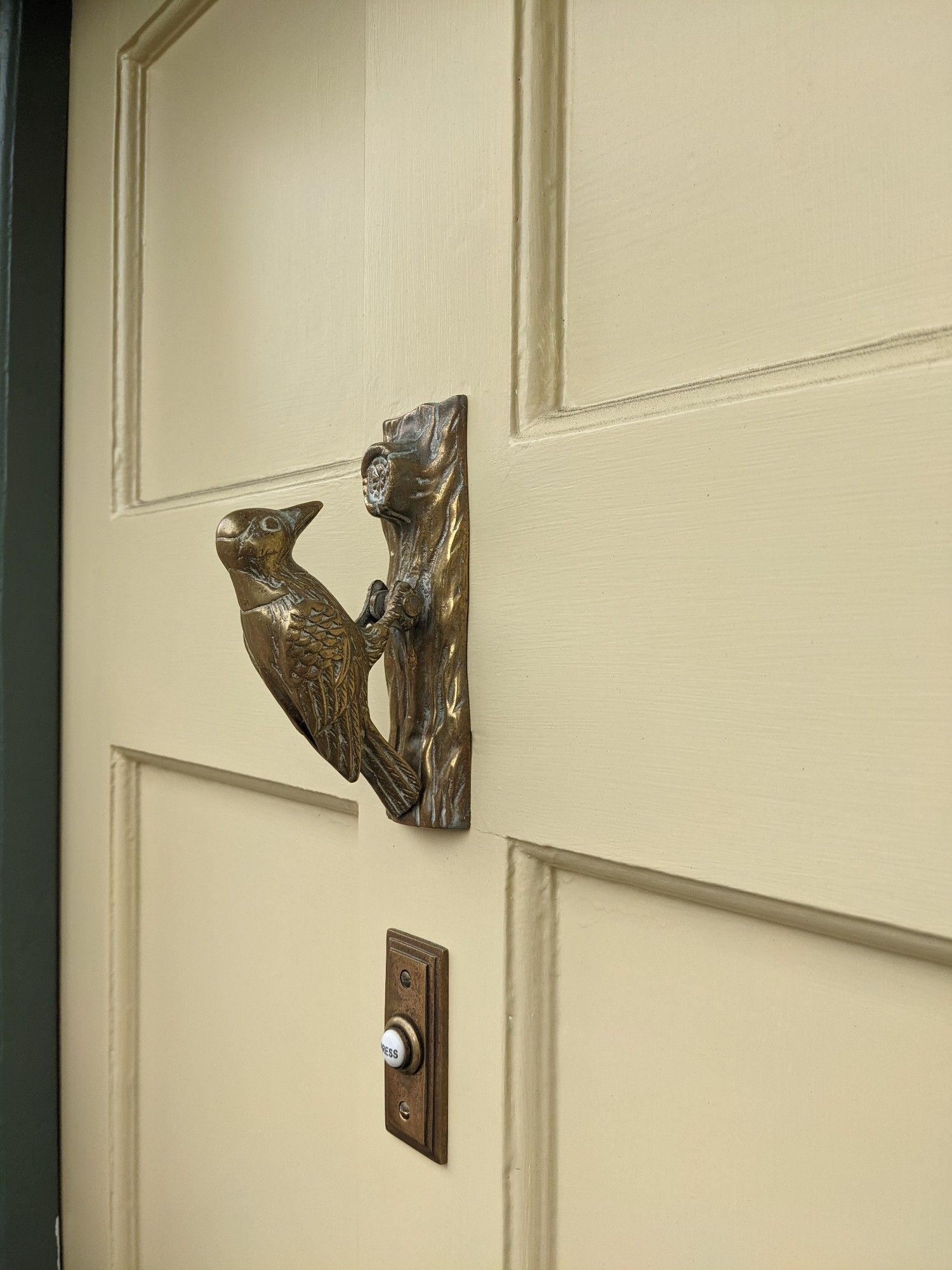 A door knocker shaped like a woodpecker