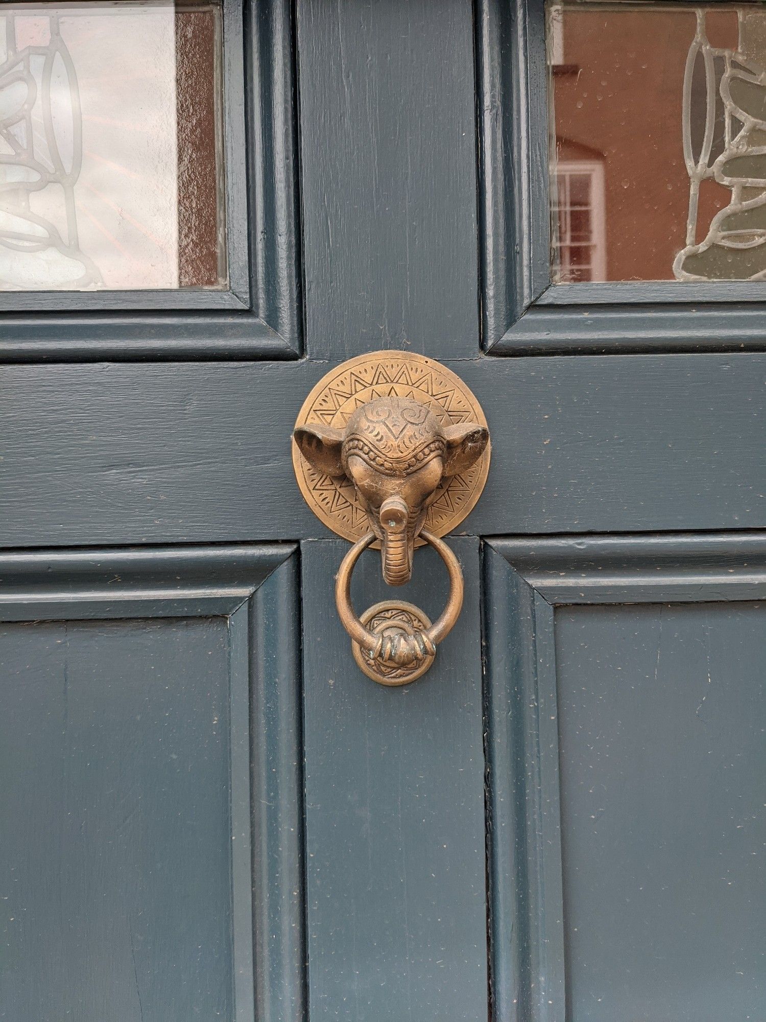 A door knocker shaped like an Indian elephant head with geometric designs