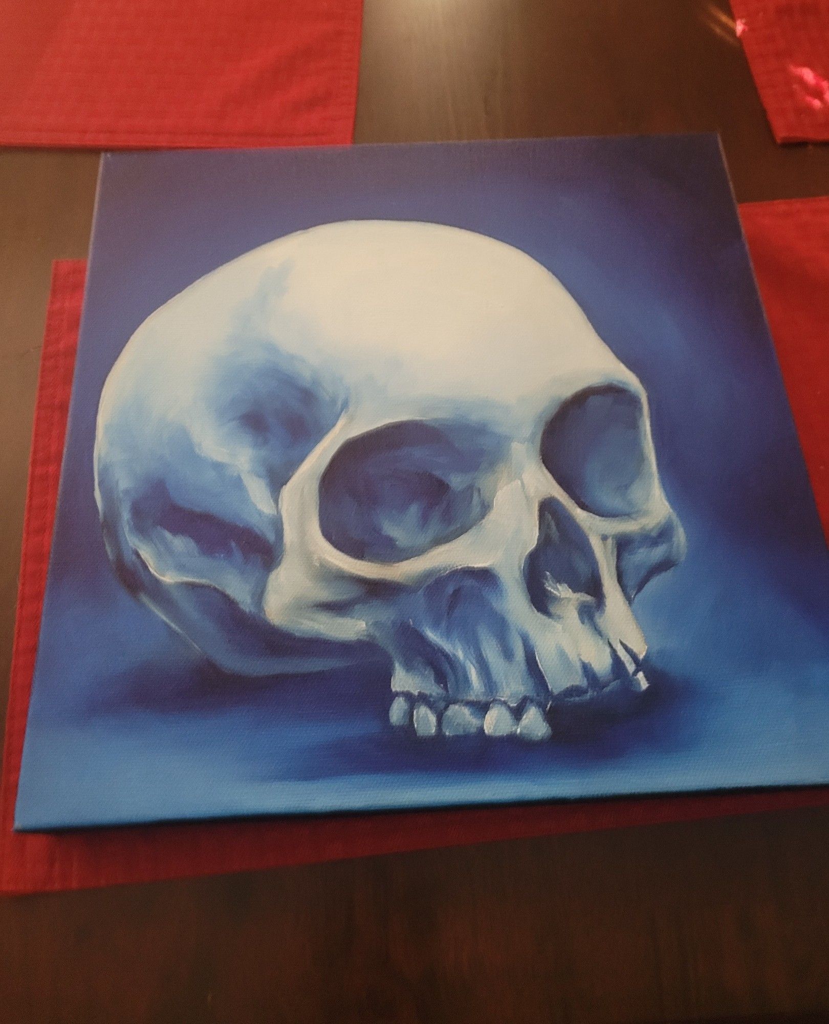 A skull with a blue background painted in acrylics looking rad as heck.