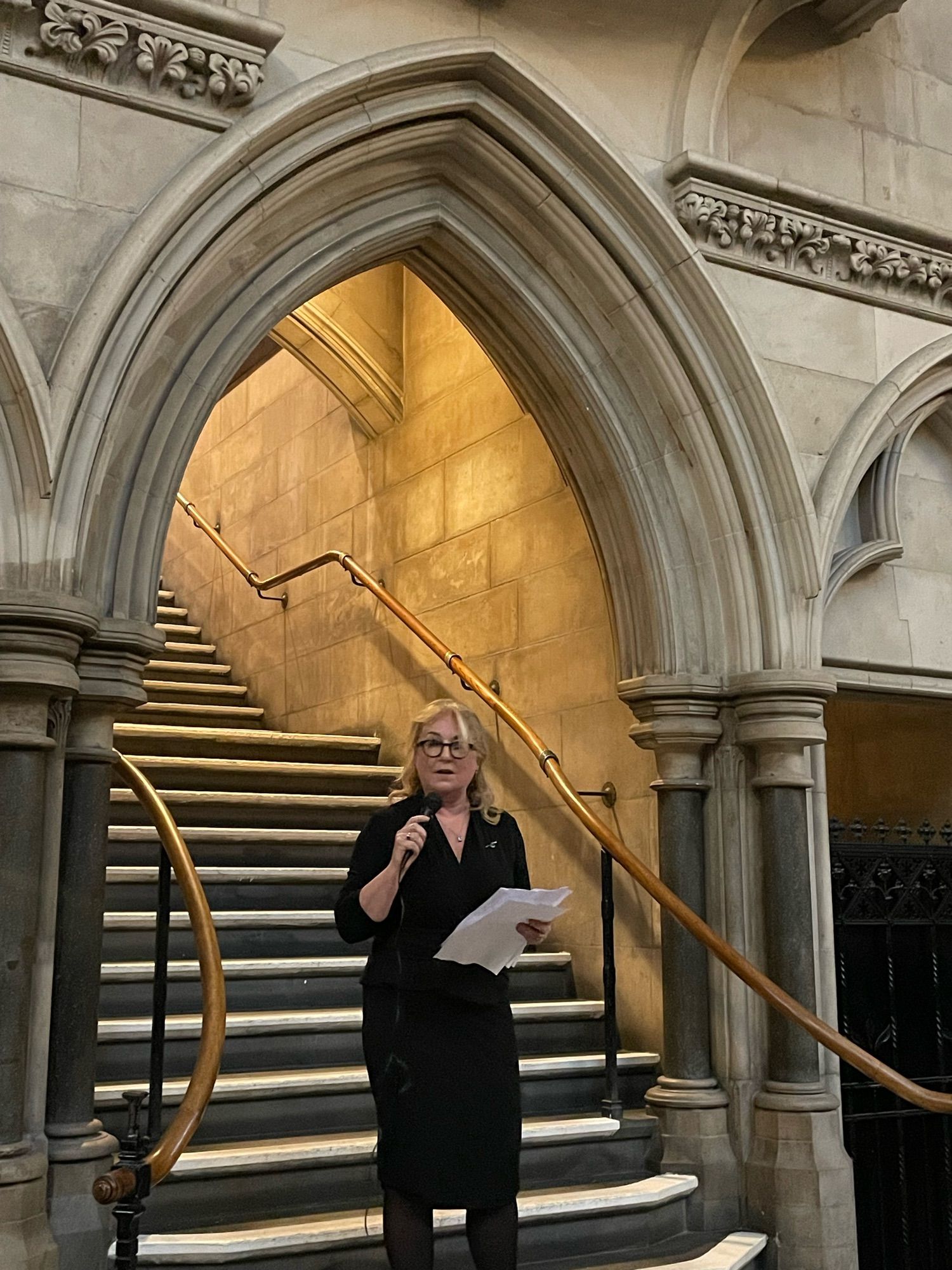 The Lady Chief Justice delivering a speech on the steps inside the Royal Courts of Justice.