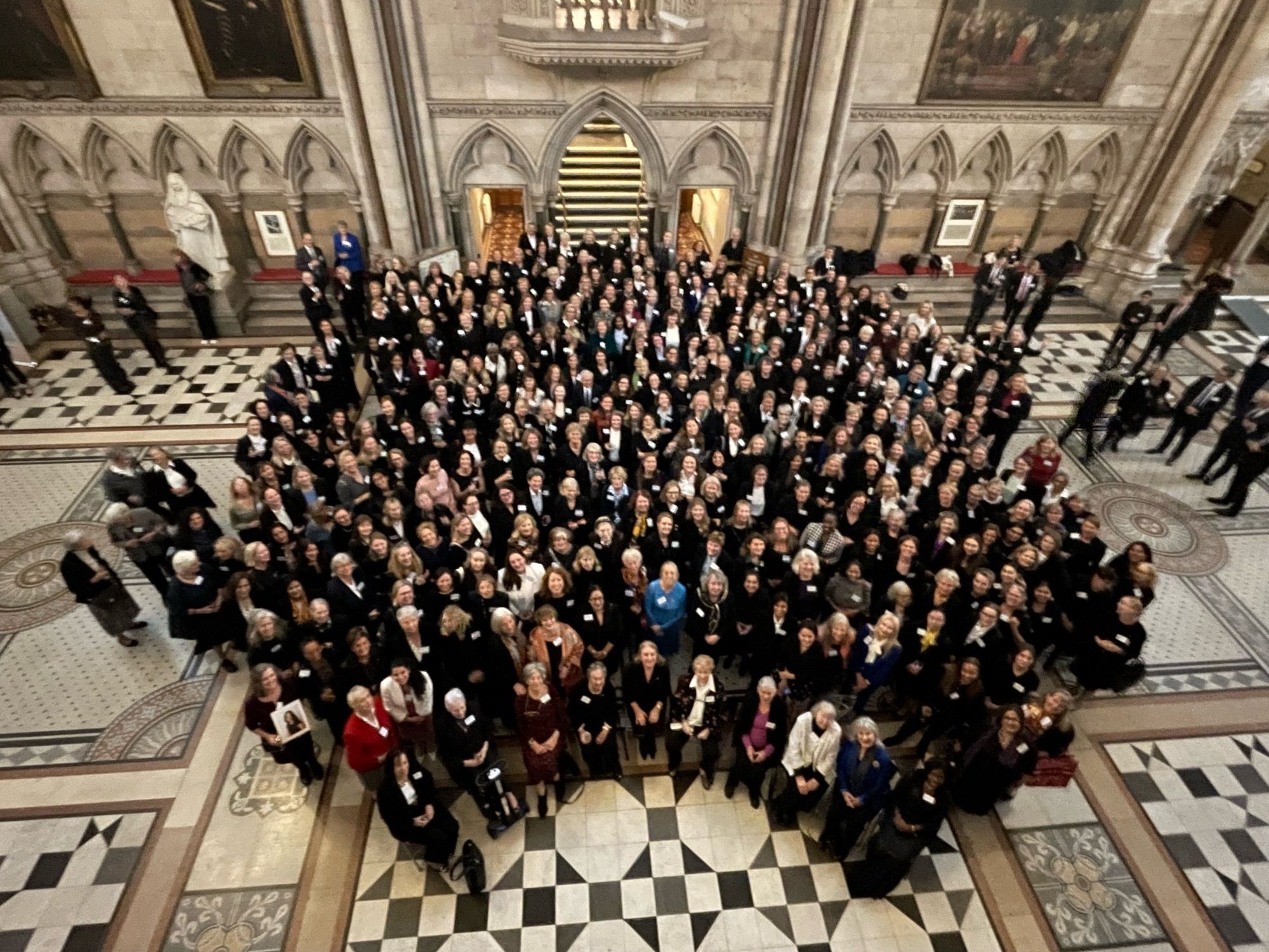 Around 350 women standing in the Great Hall of the Royal Courts of Justice with the photograph taken from above