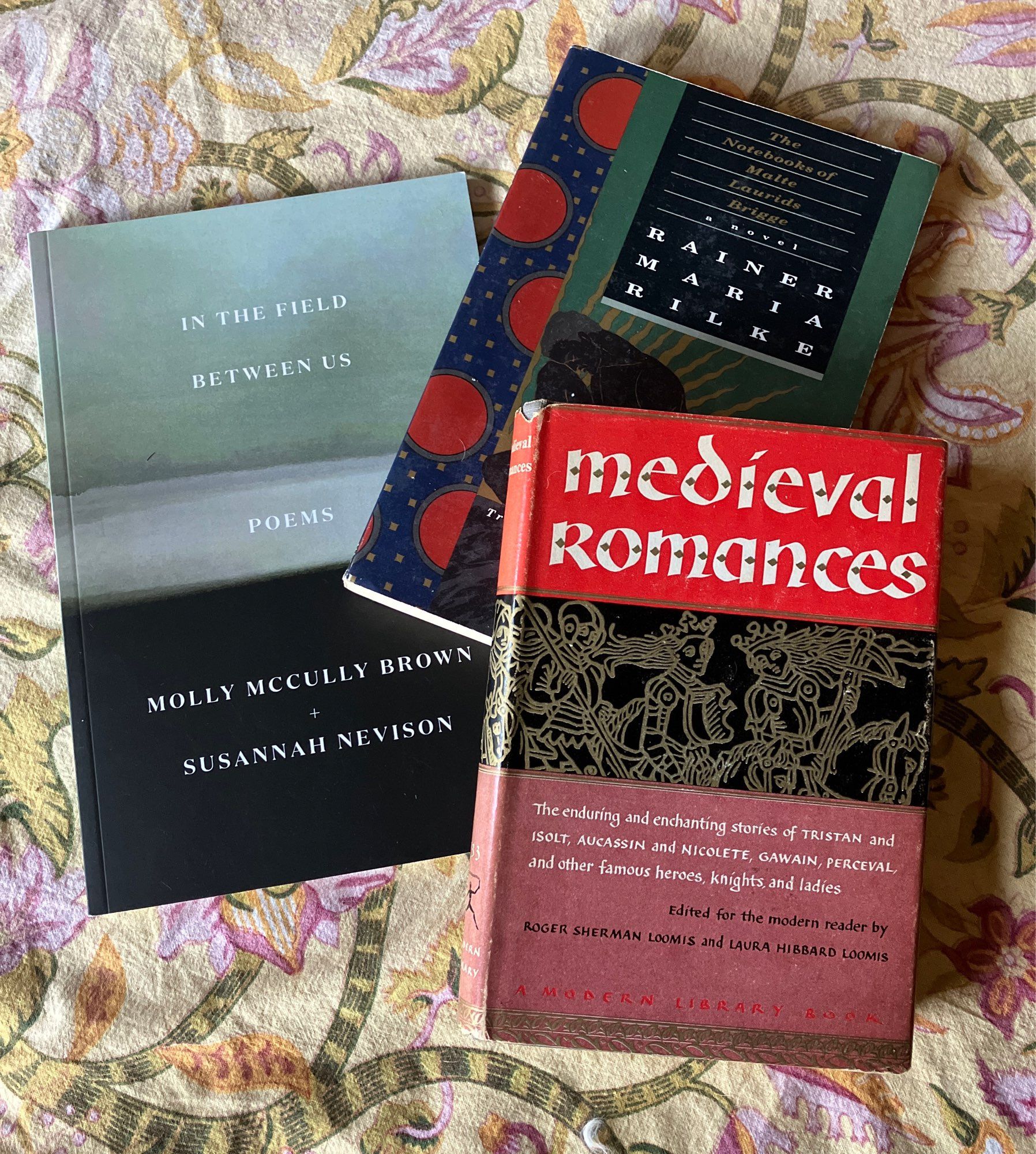 3 used books: In the Field Between Us by Molly McCully Brown and Susannah Nevison; The Notebooks of Malte Laurids Brigge by Rainer Maria Rilke; Medieval Romances, a Modern Library Book from 1957