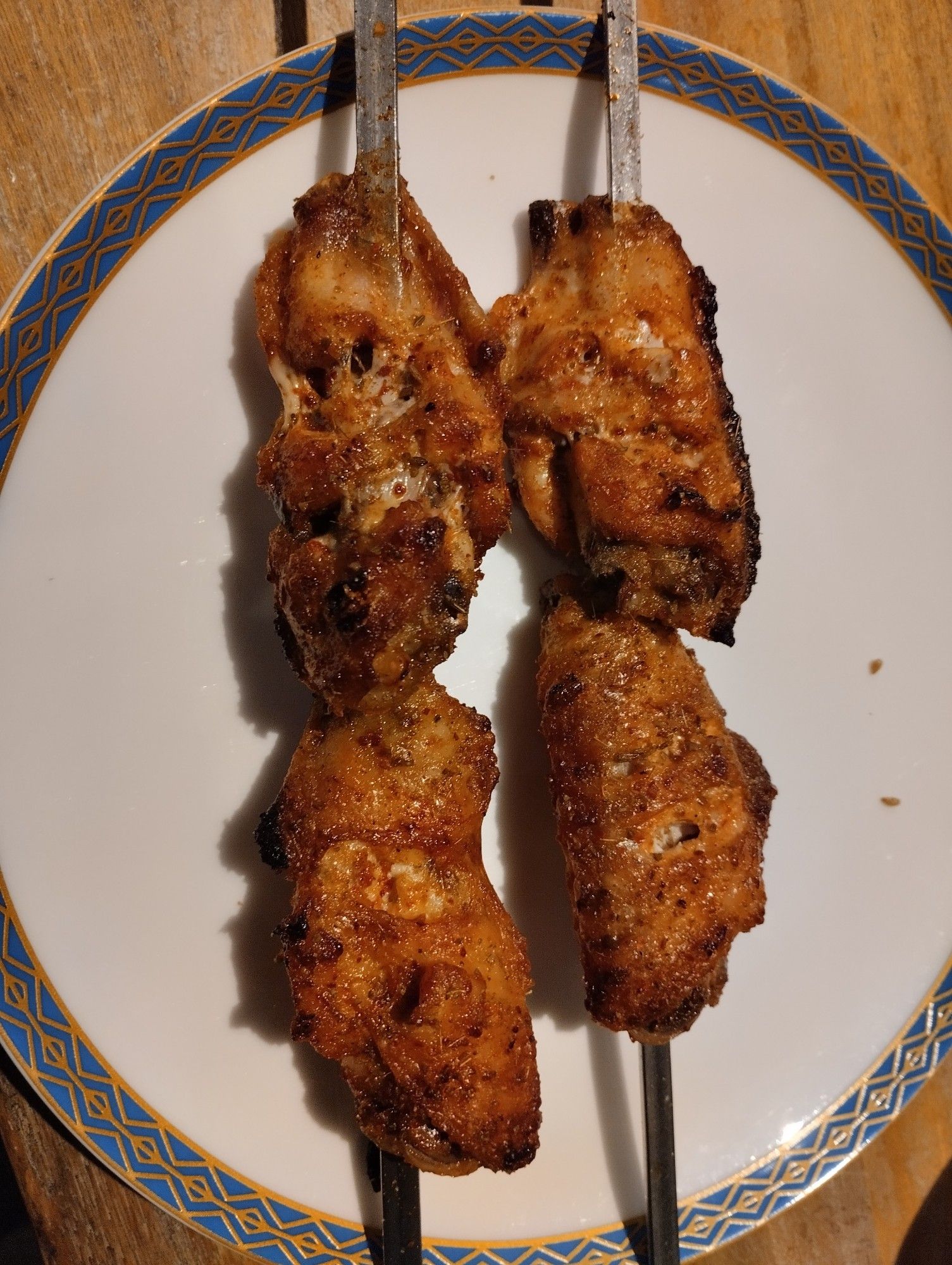 Roast chicken wing skewers on a plate