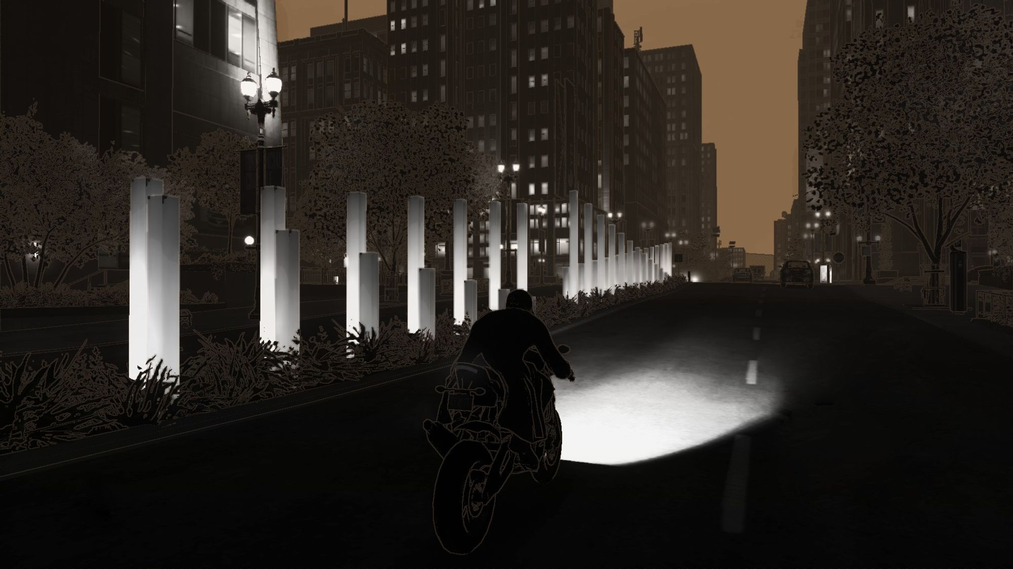 A person rides a motorcycle down a dimly lit city street at night, with illuminated columns lining the road.