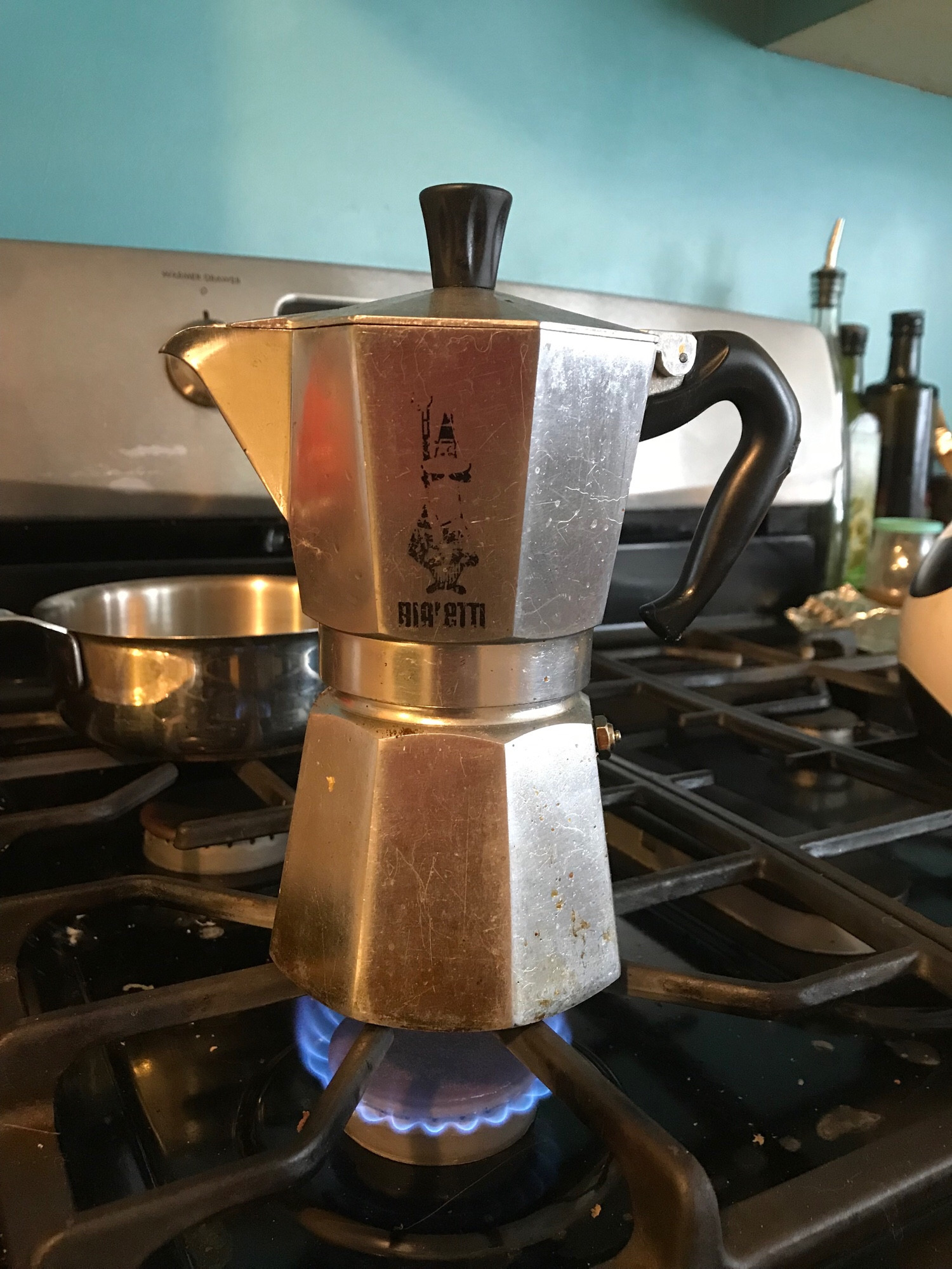 A photo of a moka pot over the gas hob,making my coffee.