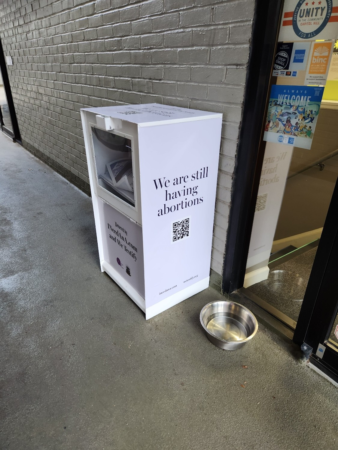 A newspaper box that reads "We Are Still Having Abortions"