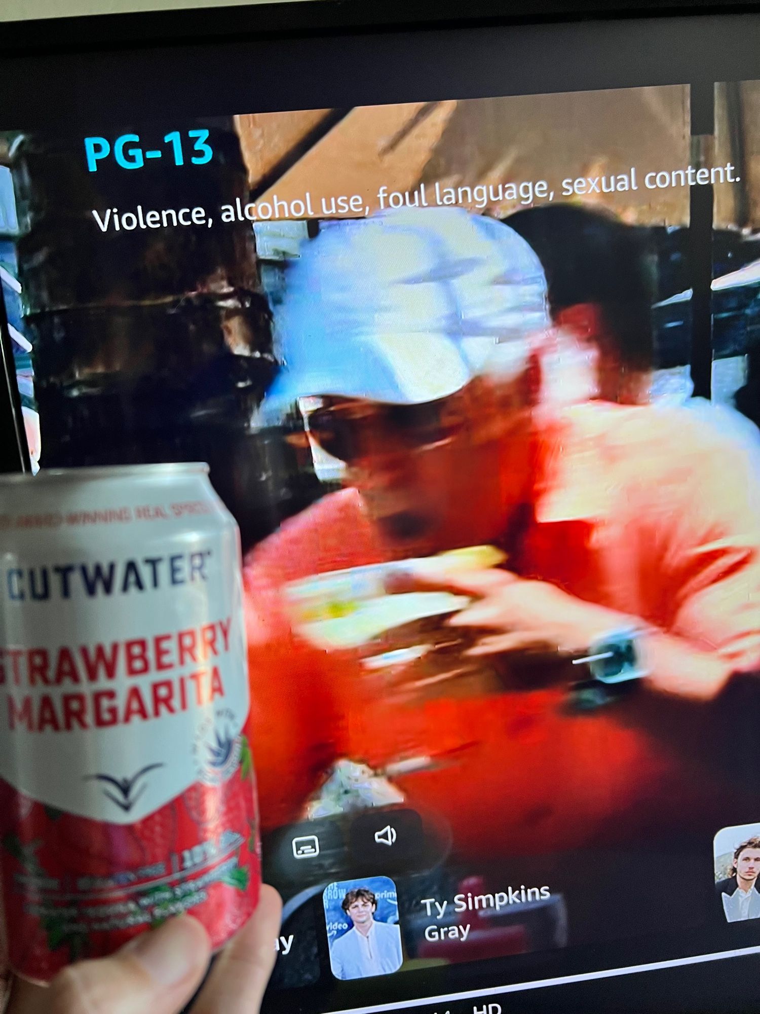 A screen grab of Jimmy Buffet saving his precious margaritas in Jurassic World, while I toast his departed spirit with a can of CutWater canner strawberry margarita. (Not great but will do in a pinch.)