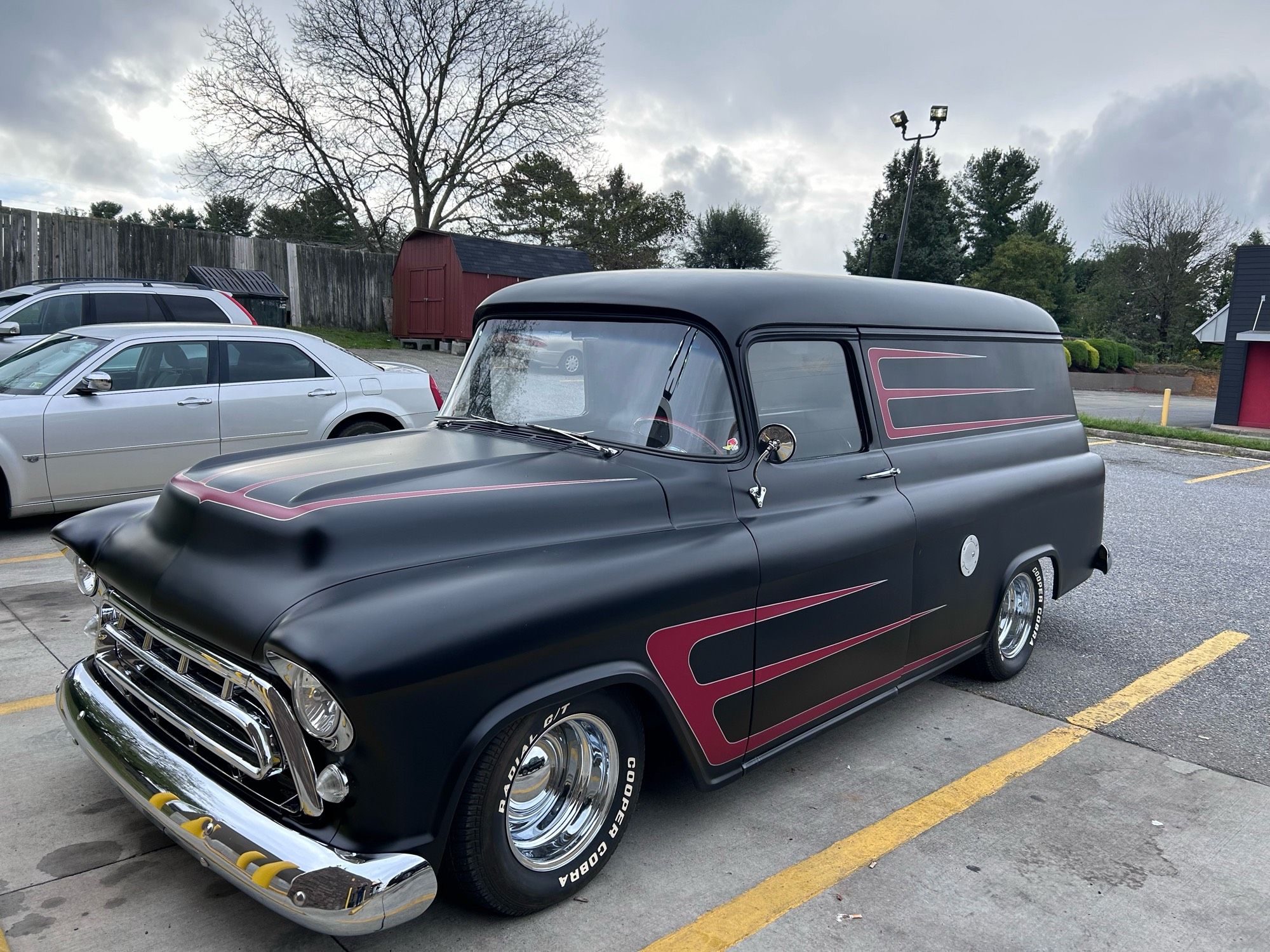 Antique van absolutely beasted out in matte black paint and red accents. Loads of chrome and fat tyres.