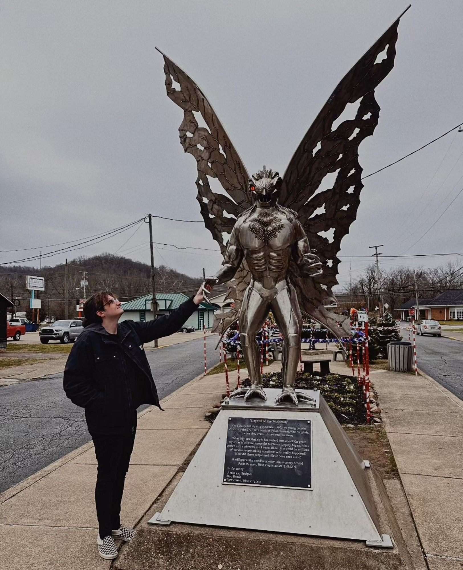 Ethan holding the Mothman statue's hand in Point Pleasant, WV.