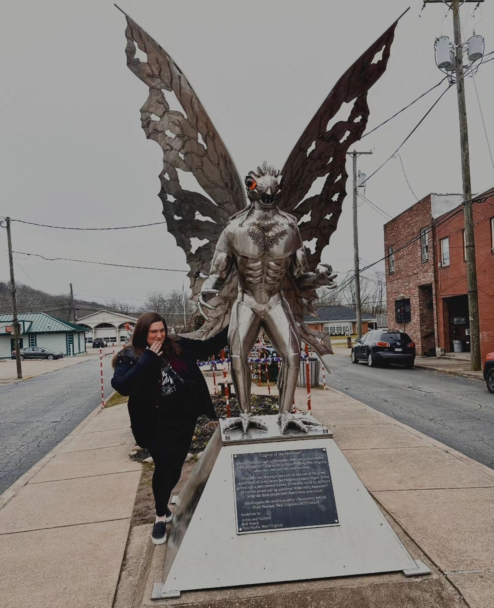 Blair touching the Mothman statue's butt in Point Pleasant, WV.