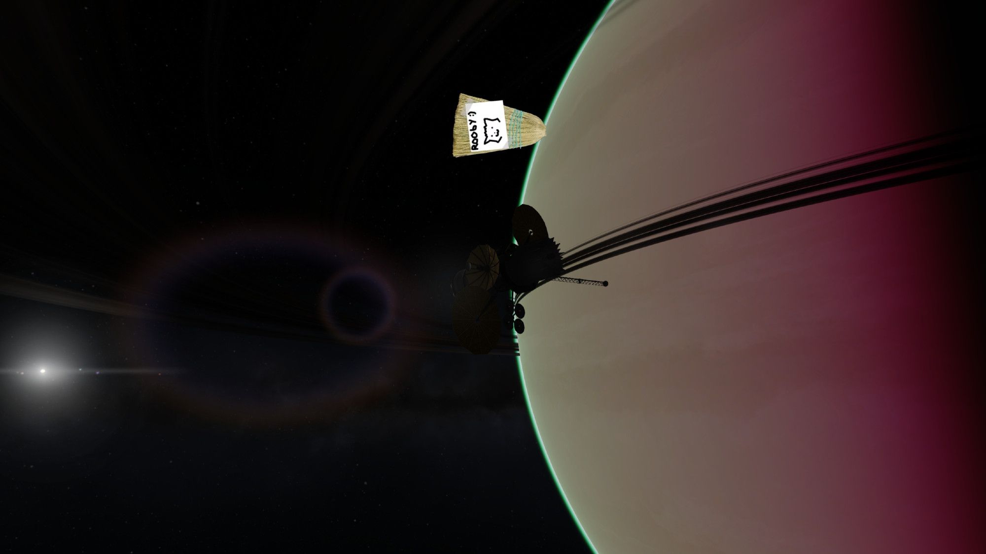 A screenshot of a probe flying by a ringed gas giant. The sun is visible yet is smaller, the probe cloaked in darkness. Our Lord Broomby is visible, peeking out from behind the planet.