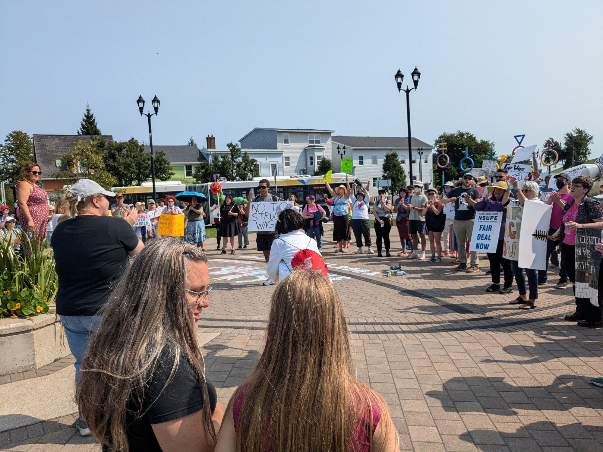 Dozens of library workers standing in a semi circle on the Halifax Common