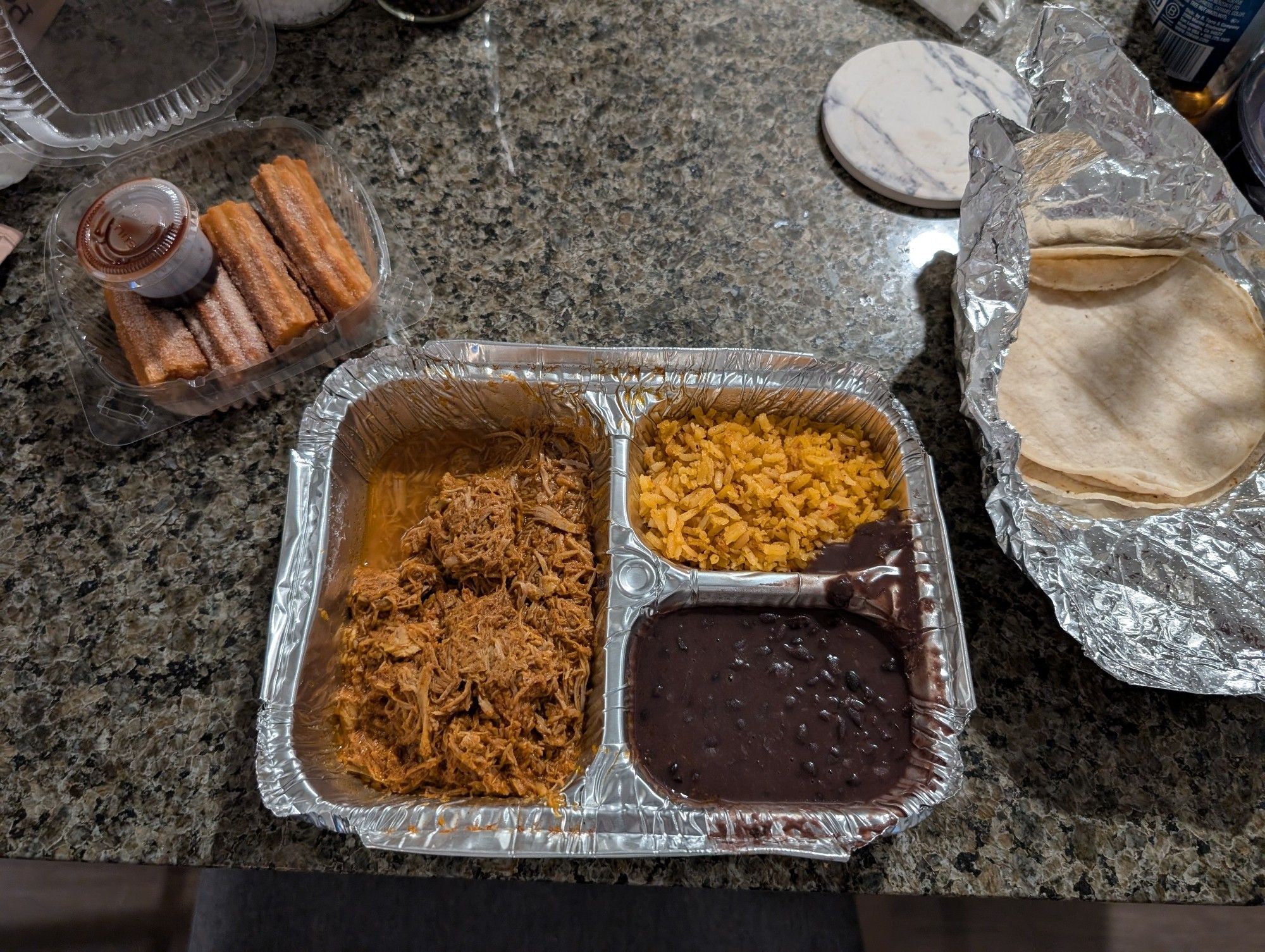 A photograph of a cochinta pibil dinner with churros.