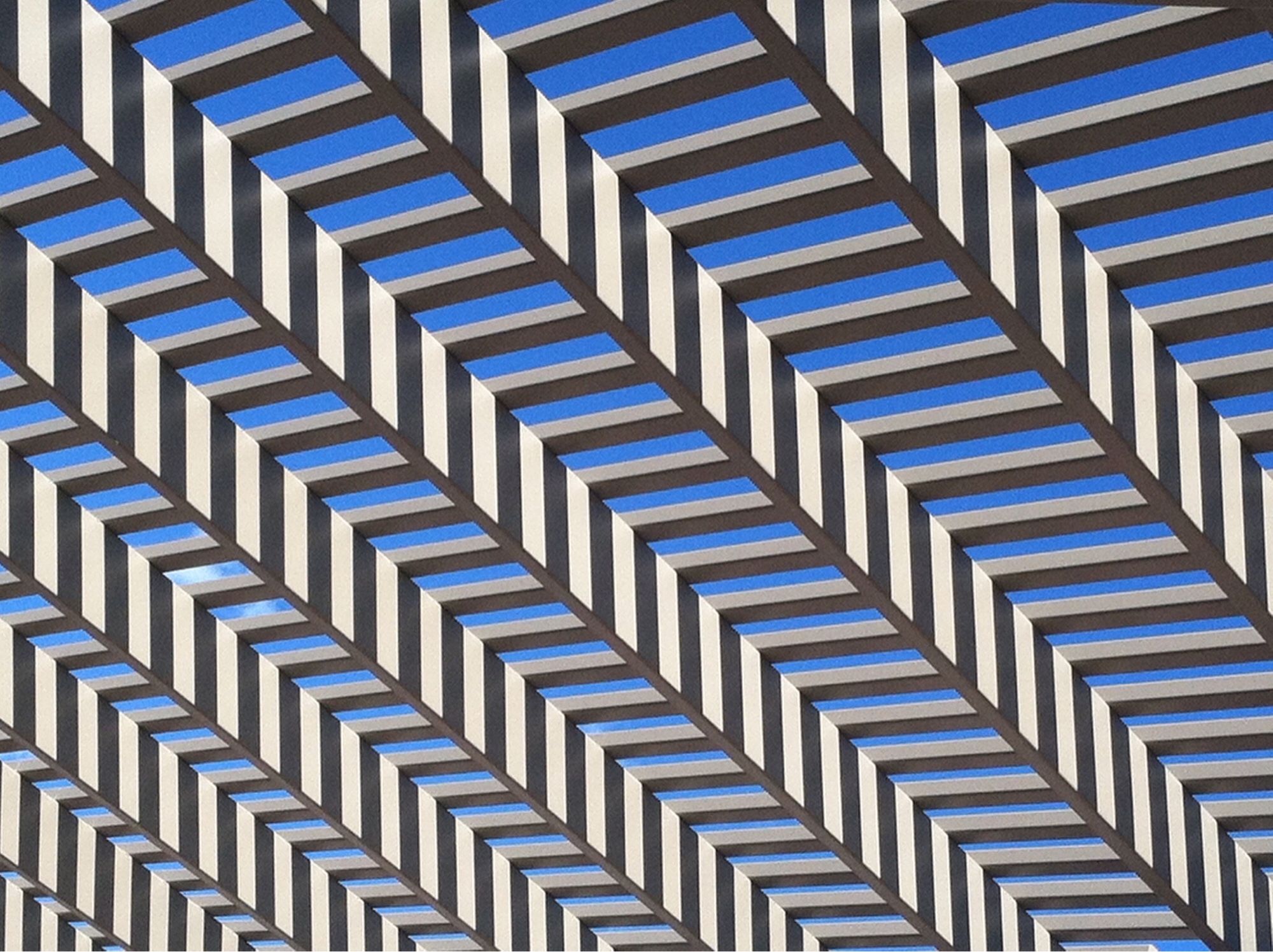 crisscrossing woods slats create a pattern on a pergola (Shell Falls, Wyoming)