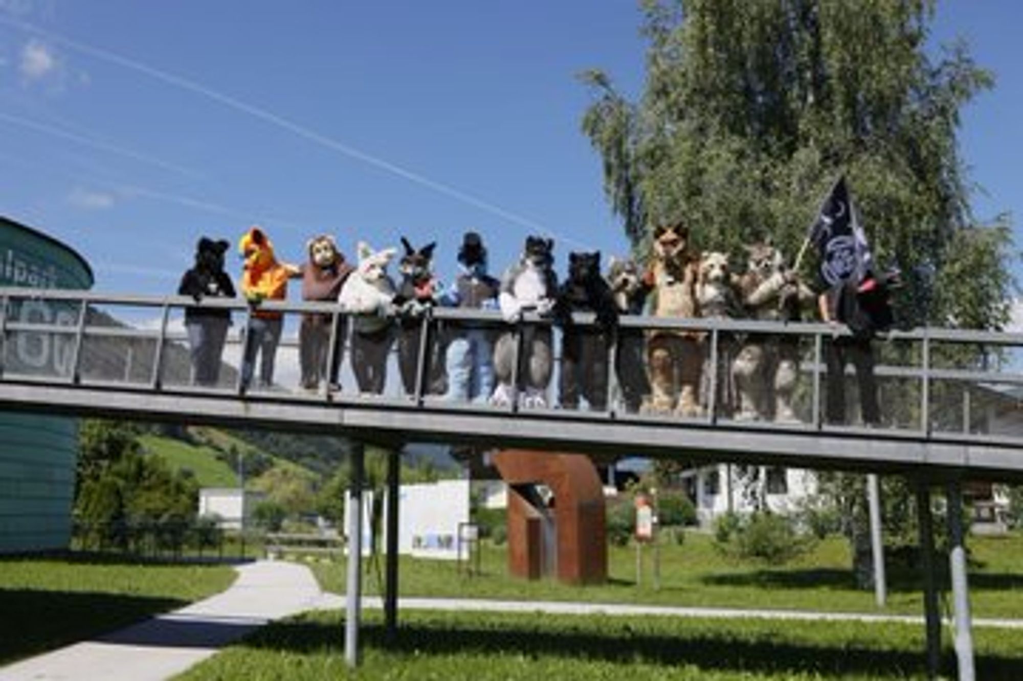 A Fursuit Photo with 13 Fursuiters Standing on a Bridge.
Photo done by Bastlwastl