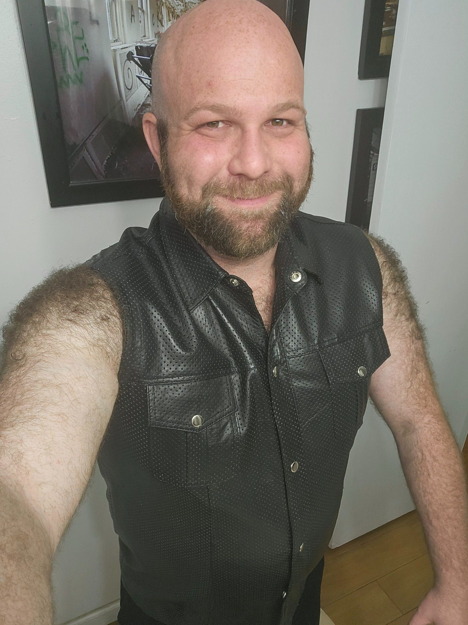 Jeremy wearing a perforated leather button down sleeveless t shirt