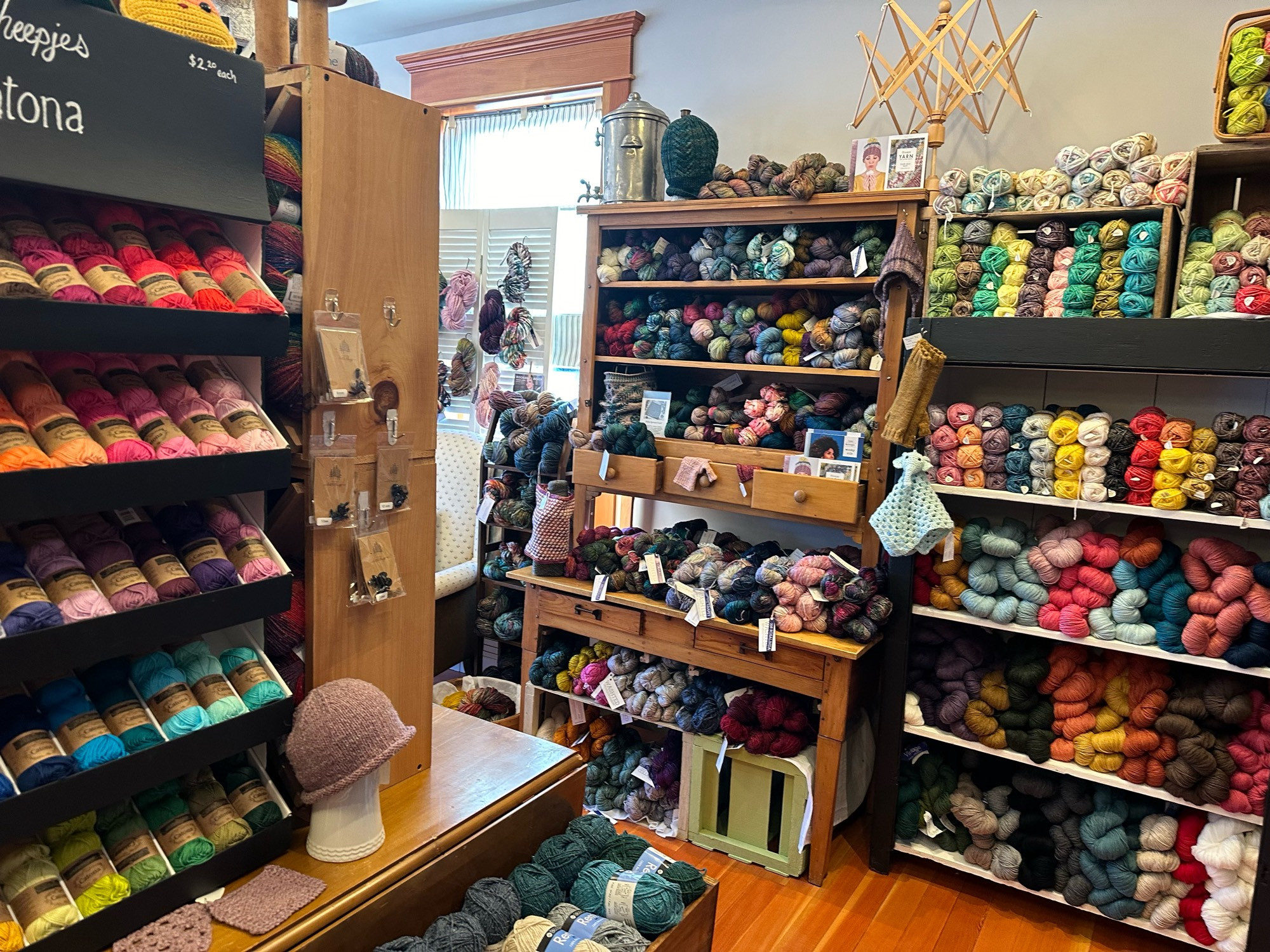 Interior of Sea Bre’s, with shelves of yummy looking yarns on cute wooden shelves