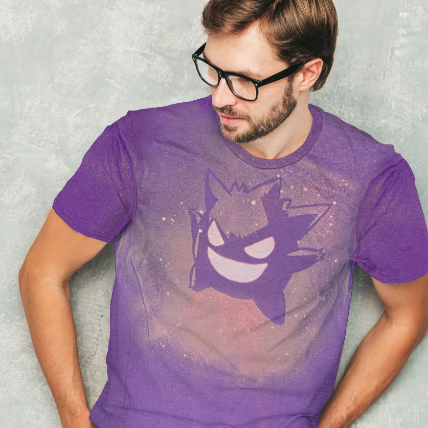 A dark-haired man wearing glasses and looking away from the camera. He is wearing a purple shirt that has a Gengar design created with bleach