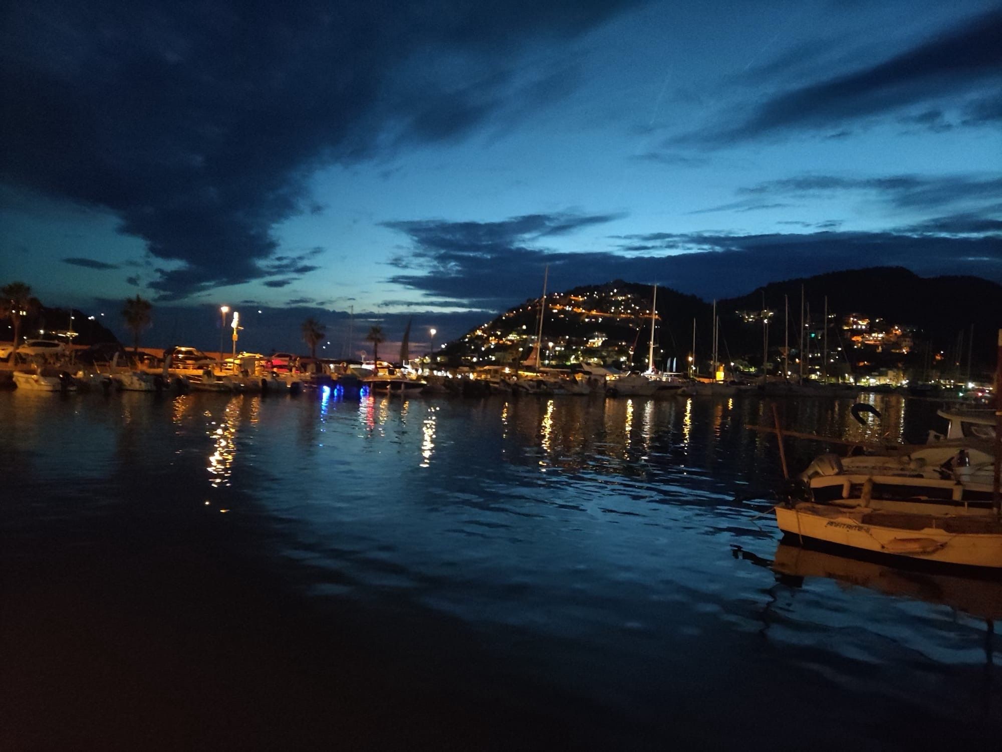 Sky at dusk over harbor scenery with dark blue water