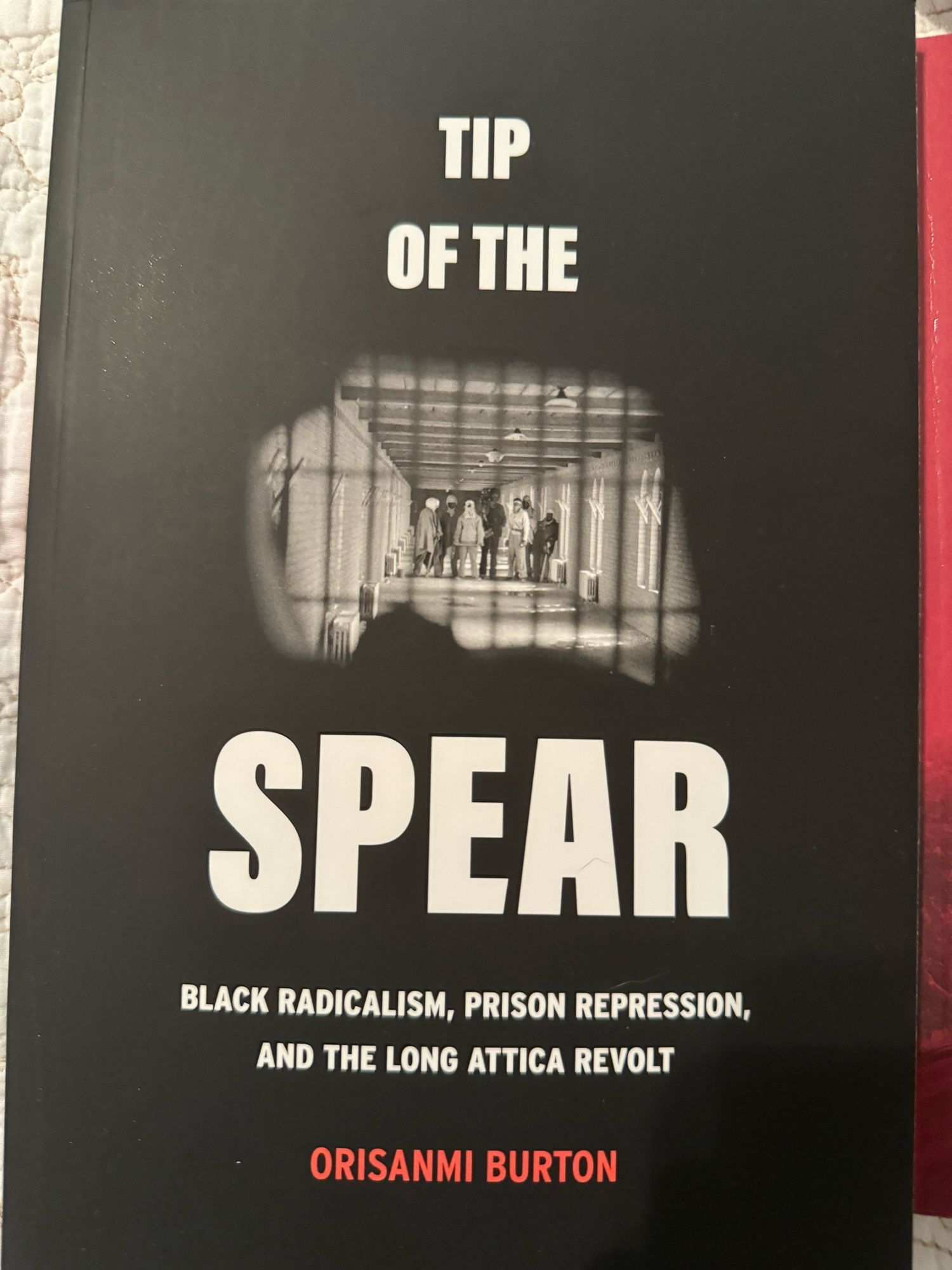 Book cover for Tip Of The Spear: Black Radicalism, Prison Repression, and the Long Attica Revolt by Orisanmi Burton.