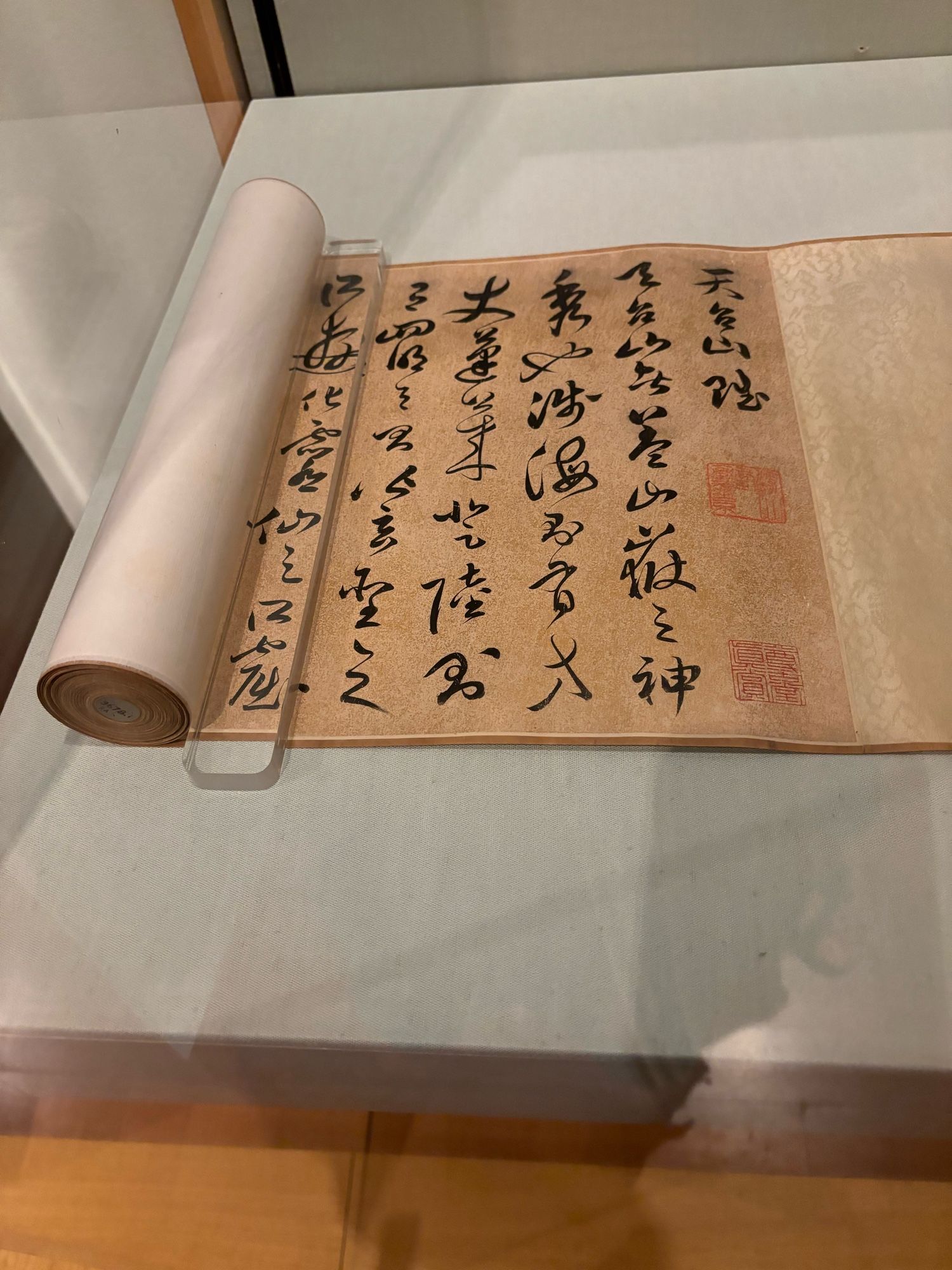 View of the calligraphic colophon with several seal impressions, at the end of a Chinese scroll painting. The text is a poem about Mt. Tiantai.