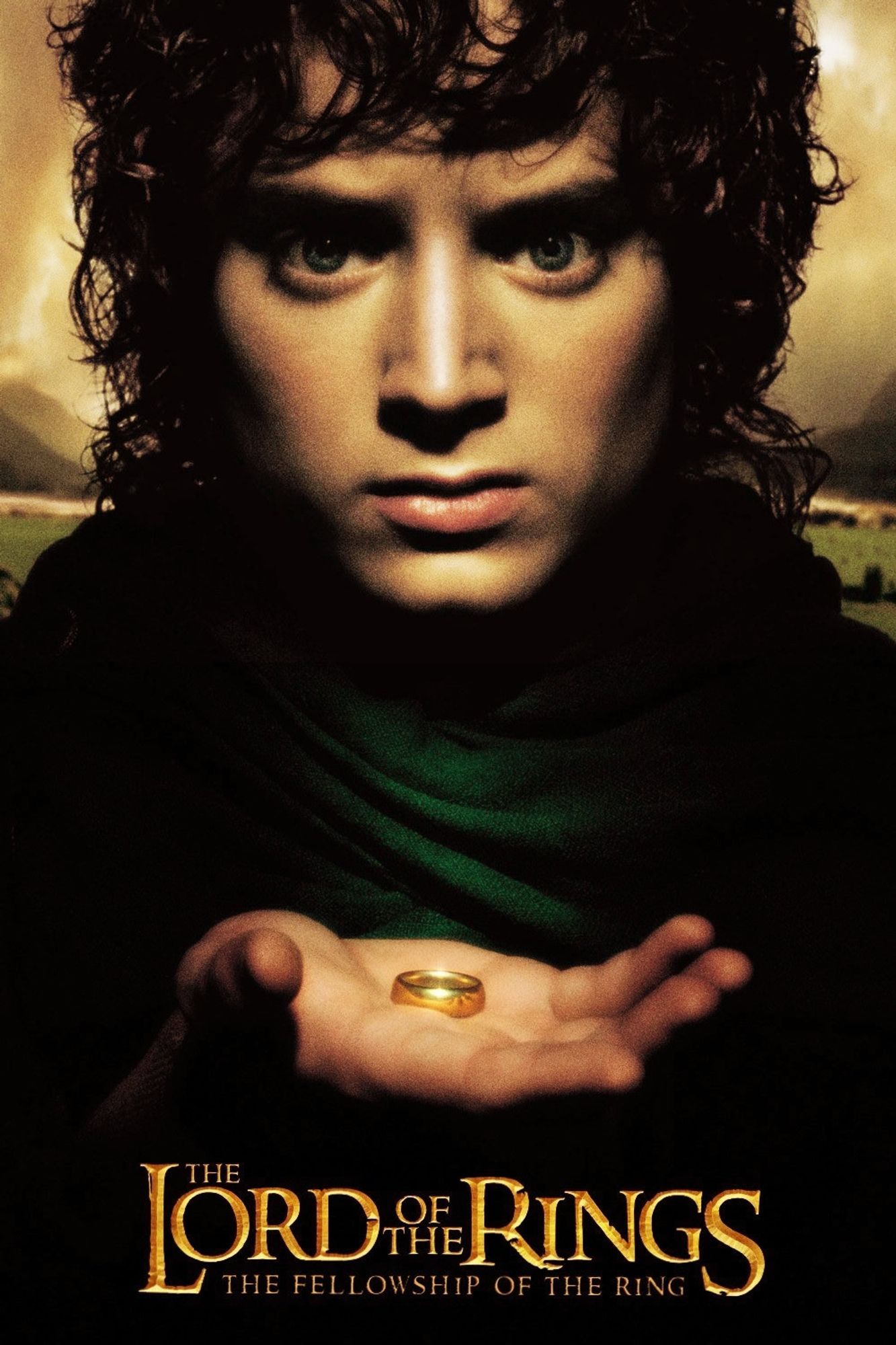 The theatrical poster for The Lord of the Rings: The Fellowship of the Ring. Frodo Baggins (played by Elijah Wood) wears a green cloak and stares into the camera solemnly, while the hand he holds up in front of his chest displays a golden ring.