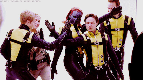 Members of the X-Men First Class ensemble crew make an 'X' symbol with their arms.