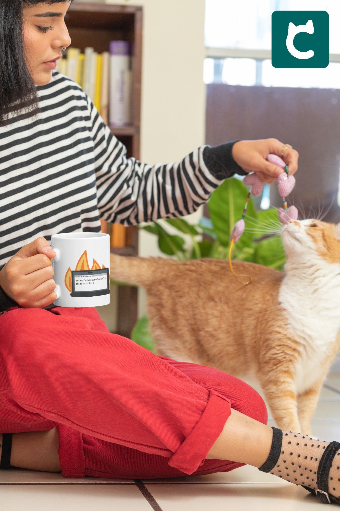 Woman holding white glossy mug with a laptop on fire and an R script that says setwd() and rm(list = ls()) and playing with cat.