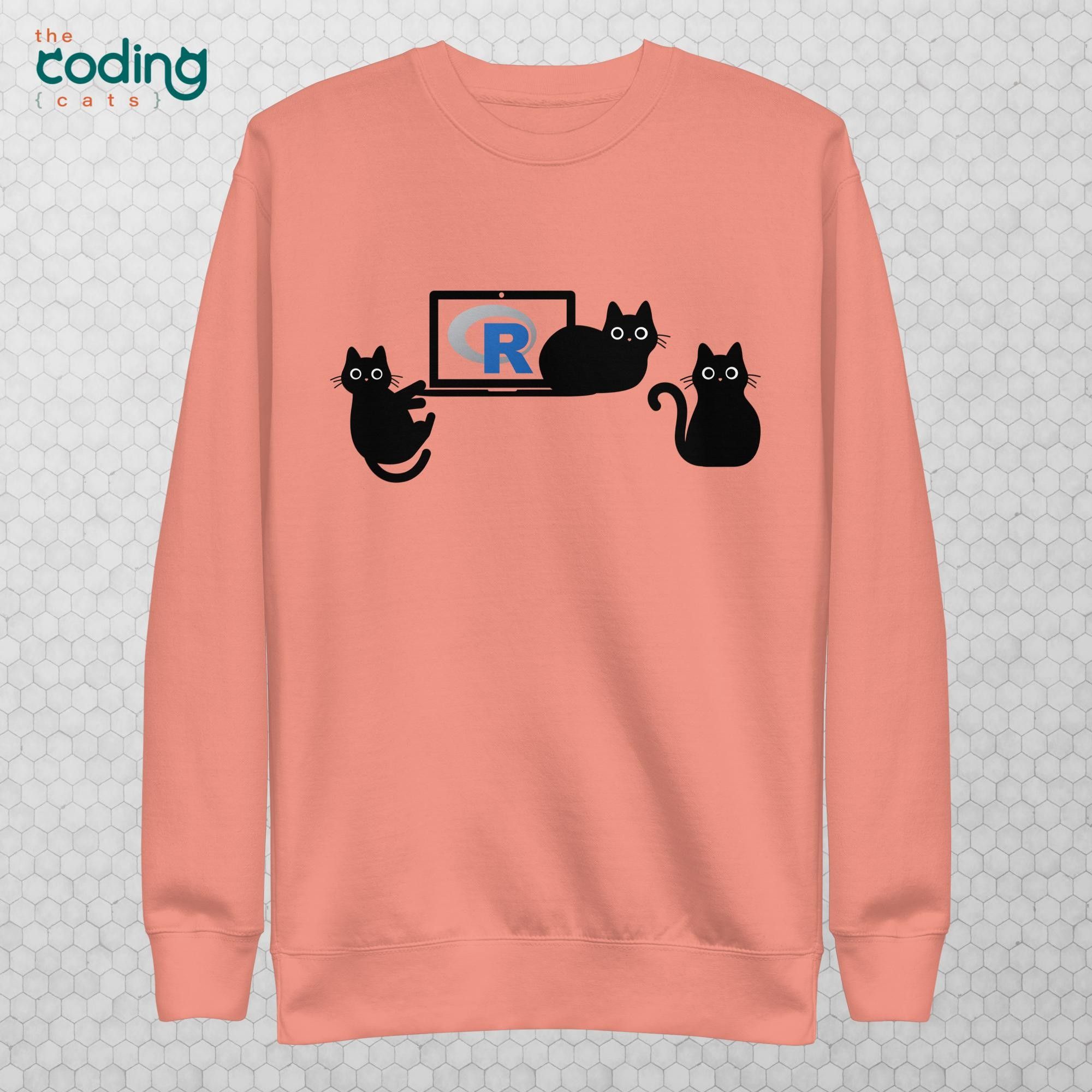 Dusty rose hooded crewneck that has three cute black cats surrounding a laptop with the R programming language on the screen.