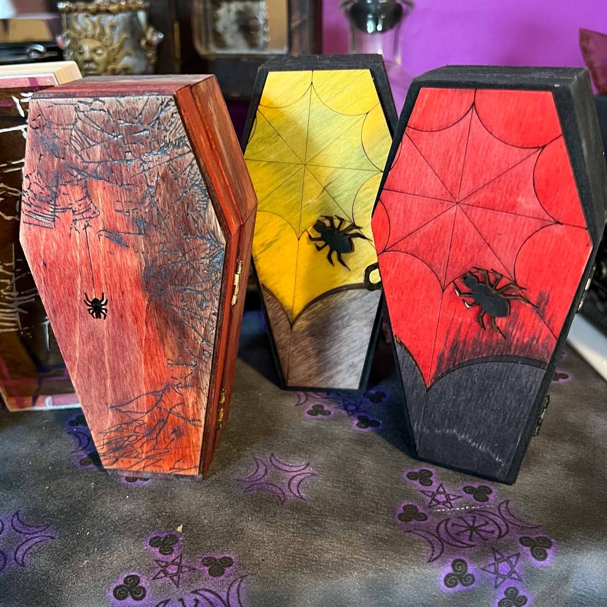 Hand decorated coffin boxes with spider and web motif