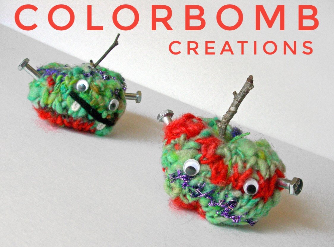 Two handmade avatar amigarumi made from handspun yarn, green with red accents and googly eyes. Text reads: Colorbomb Creations