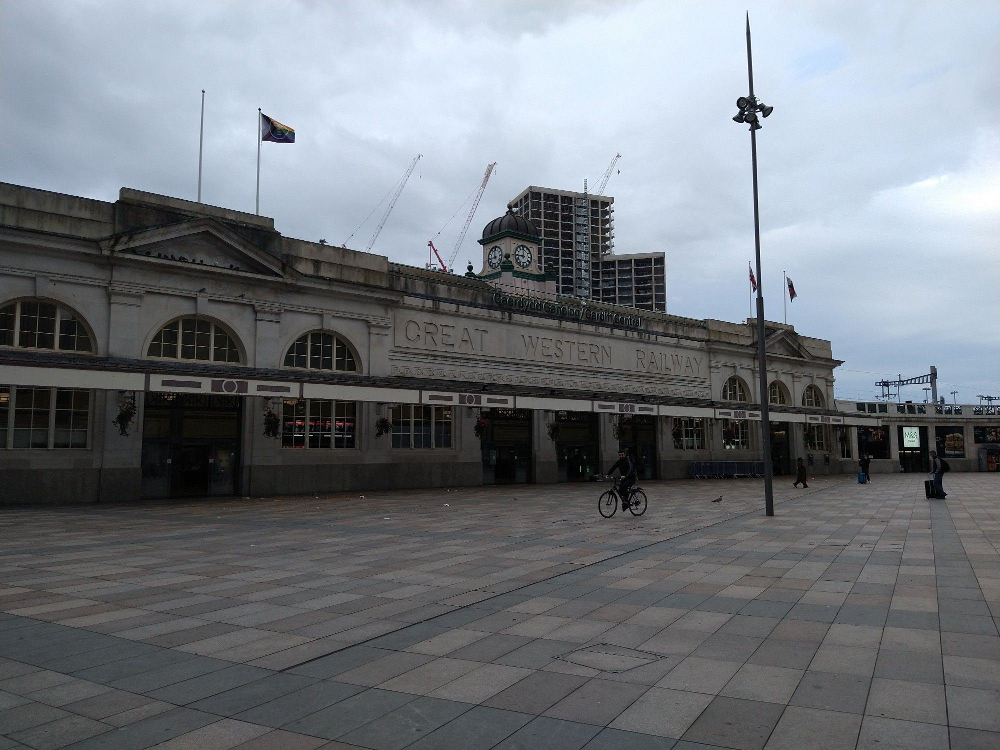 The exterior of Cardiff Central station under a dull grey sky.