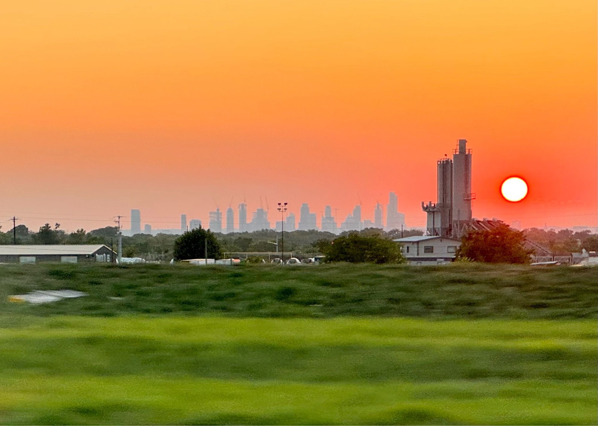 City skyline with the sun to the right