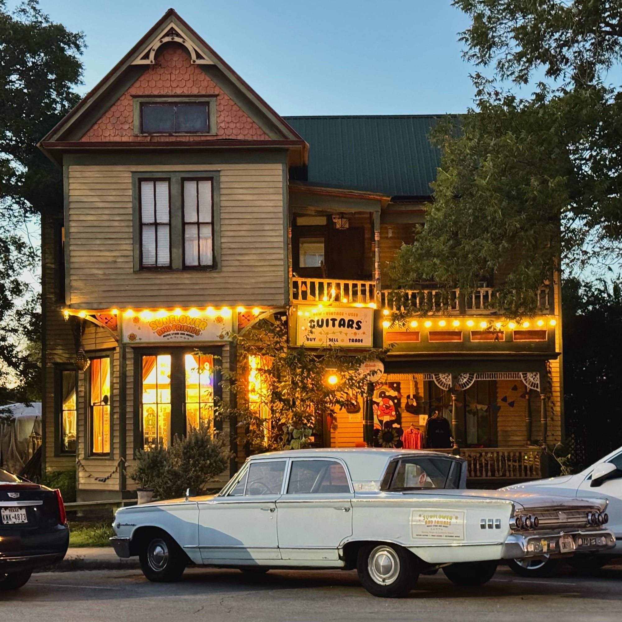 Photo of an older two story home converted to a music shop. 1963 mercury parked out front. It’s a vibe for sure