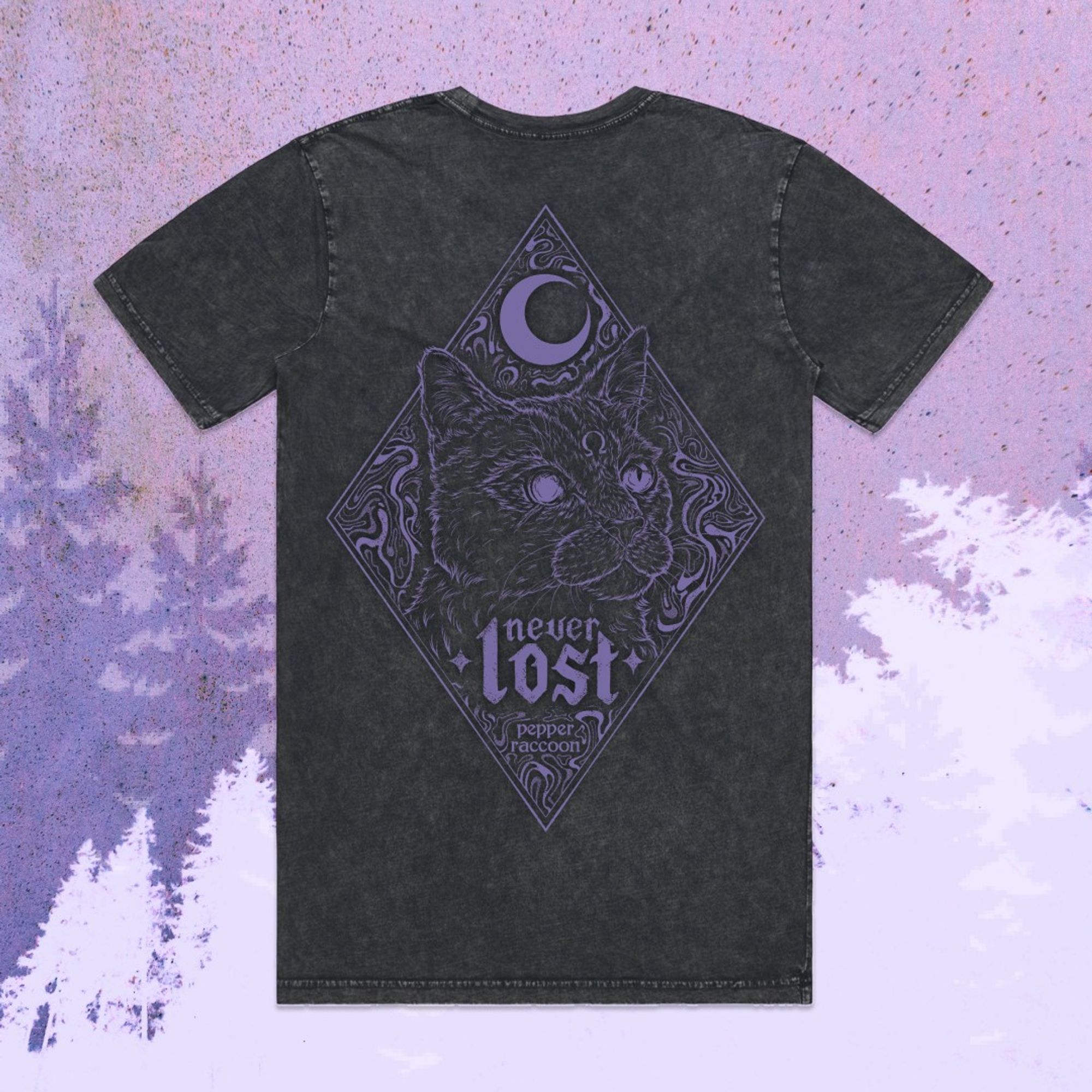 A digital flatlay of Pepper Raccoon's never lost tee. The shirt is stonewashed black (faded texture), with a back print of a grizzled cat under a crescent moon. He's surrounded by trippy swirls, with the text "Never Lost" under his chin. The entire artwork is encased in a diamond shape.