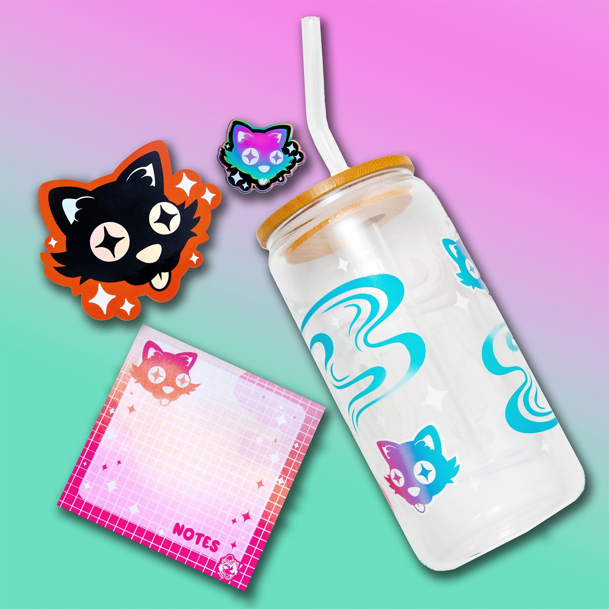 The Cosmic Cat series from Pepper Raccoon, featuring a cute glass cup with bamboo lid and straw with a starry-eyed kitty, and matching sticker, rainbow pin, and sticky notes.