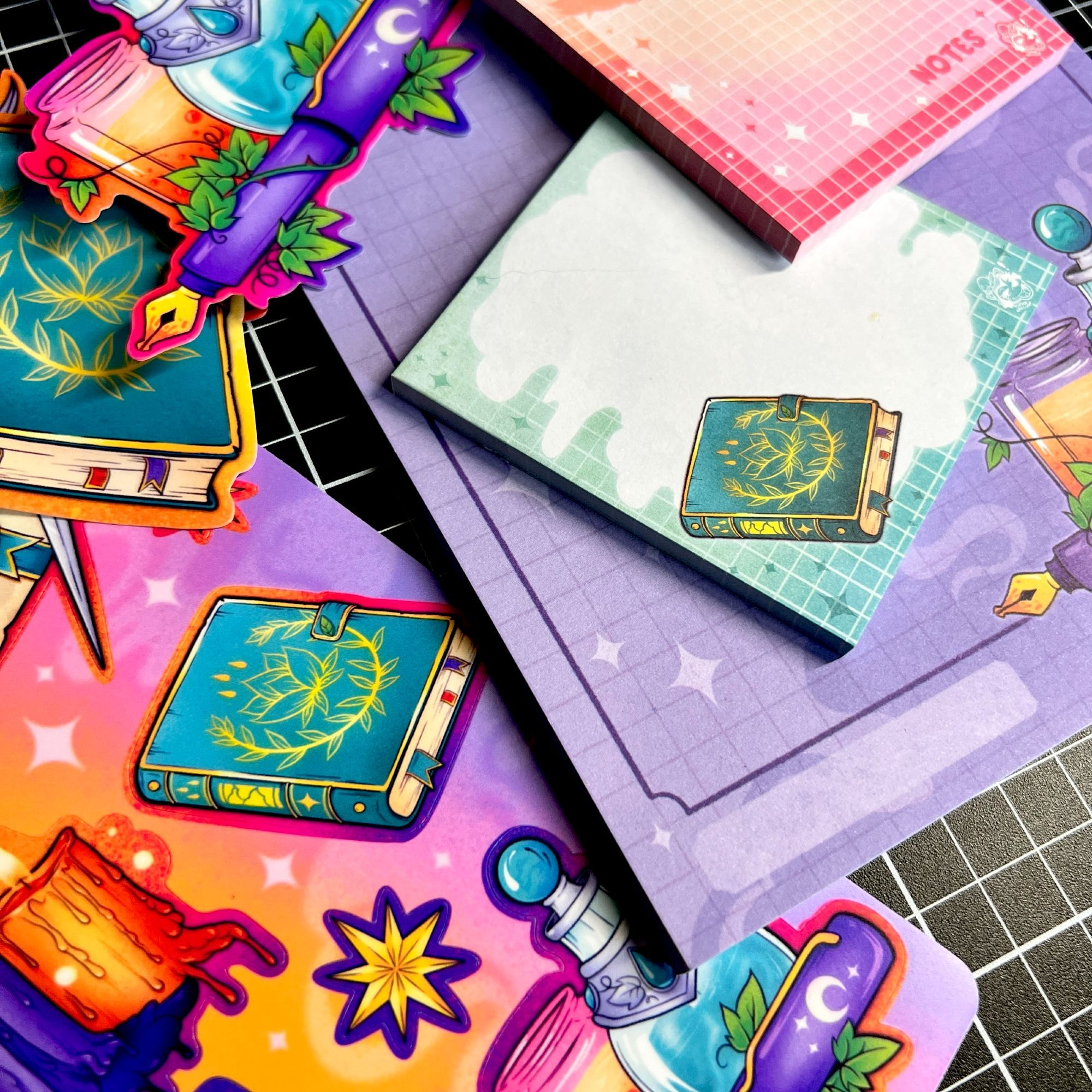 A close up photo of the Spells + Sparkles collection mentioned in the earlier image, featuring witchy notepads and stickers.