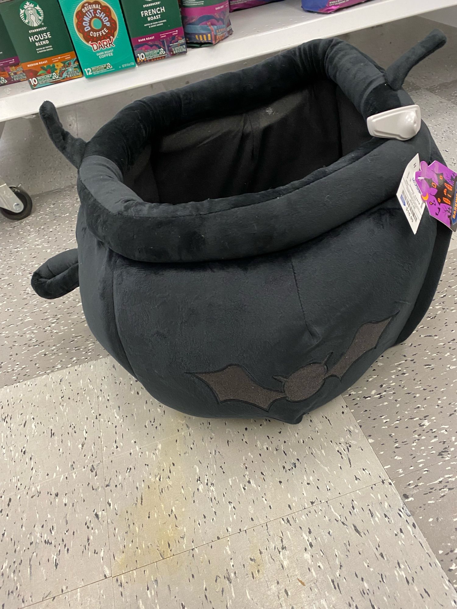 A cozy black cauldron pet bed