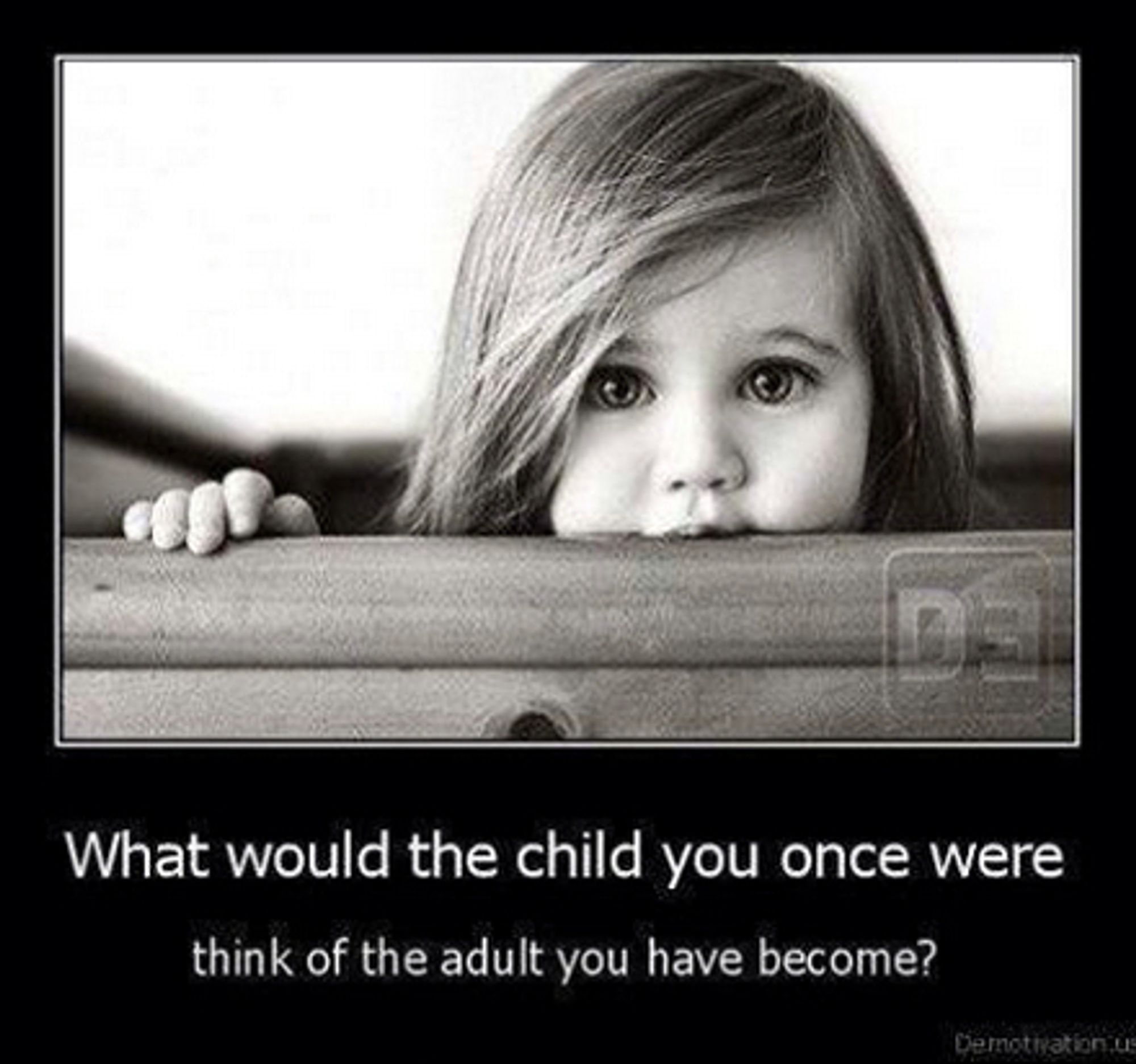 A black and white photo of a young child looking directly at the camera, her hand on a wooden rail as her face rests against the rail.