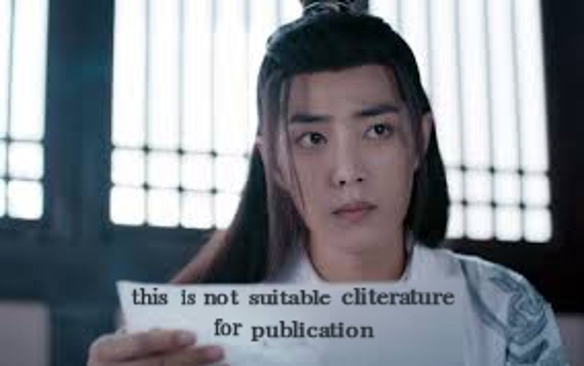 Wei Wuxian holding a piece of paper with the words this is not suitable cliterature for publication on it