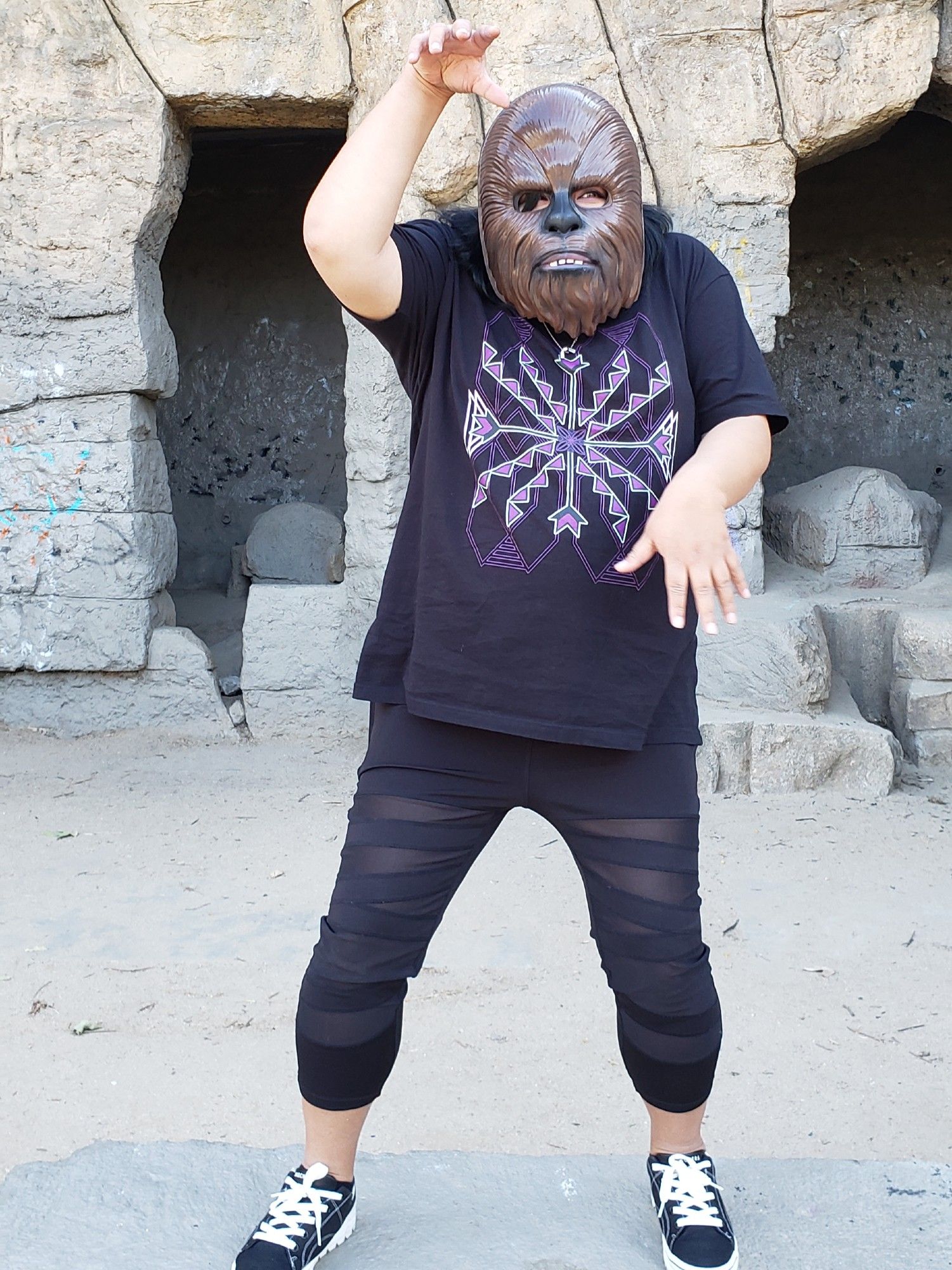 Johnnie Jae posing like an creeping monster while wearing a wookie mask.