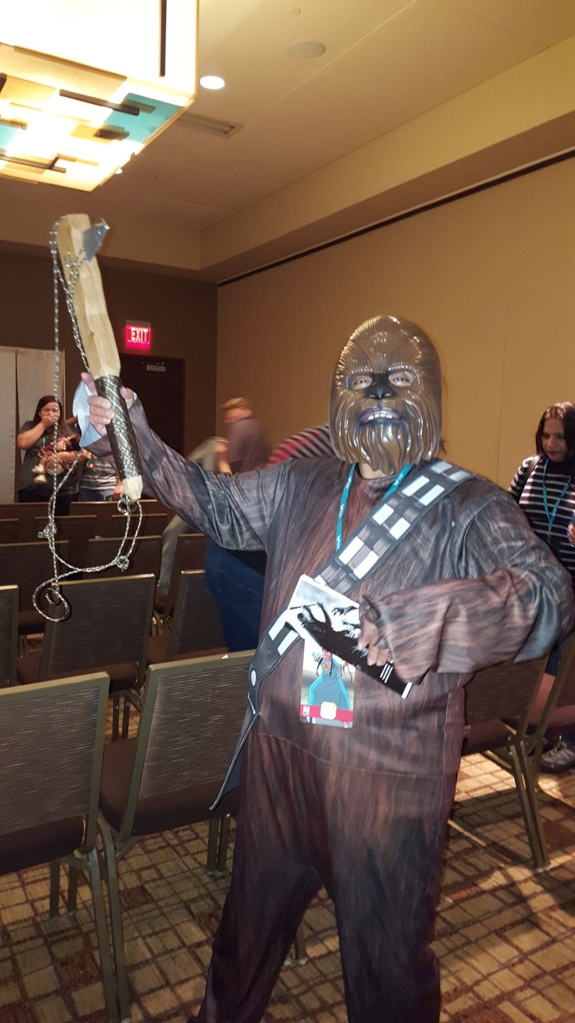 Johnnie's Mom aka Wookie Mom wearing a full wookie costume and holding Johnnie's Zombie Whacker at the 2018 Indigenous Comic Con