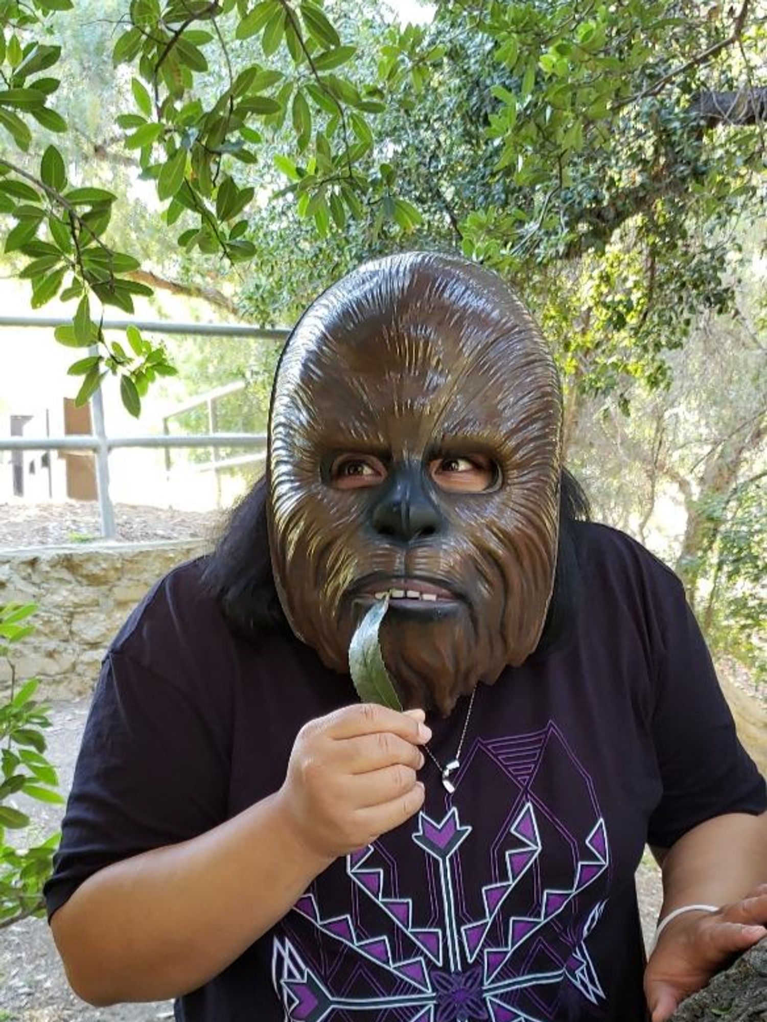 Johnnie Jae wearing a wookie mask while holding a leaf like it's the most delicious morsel ever!