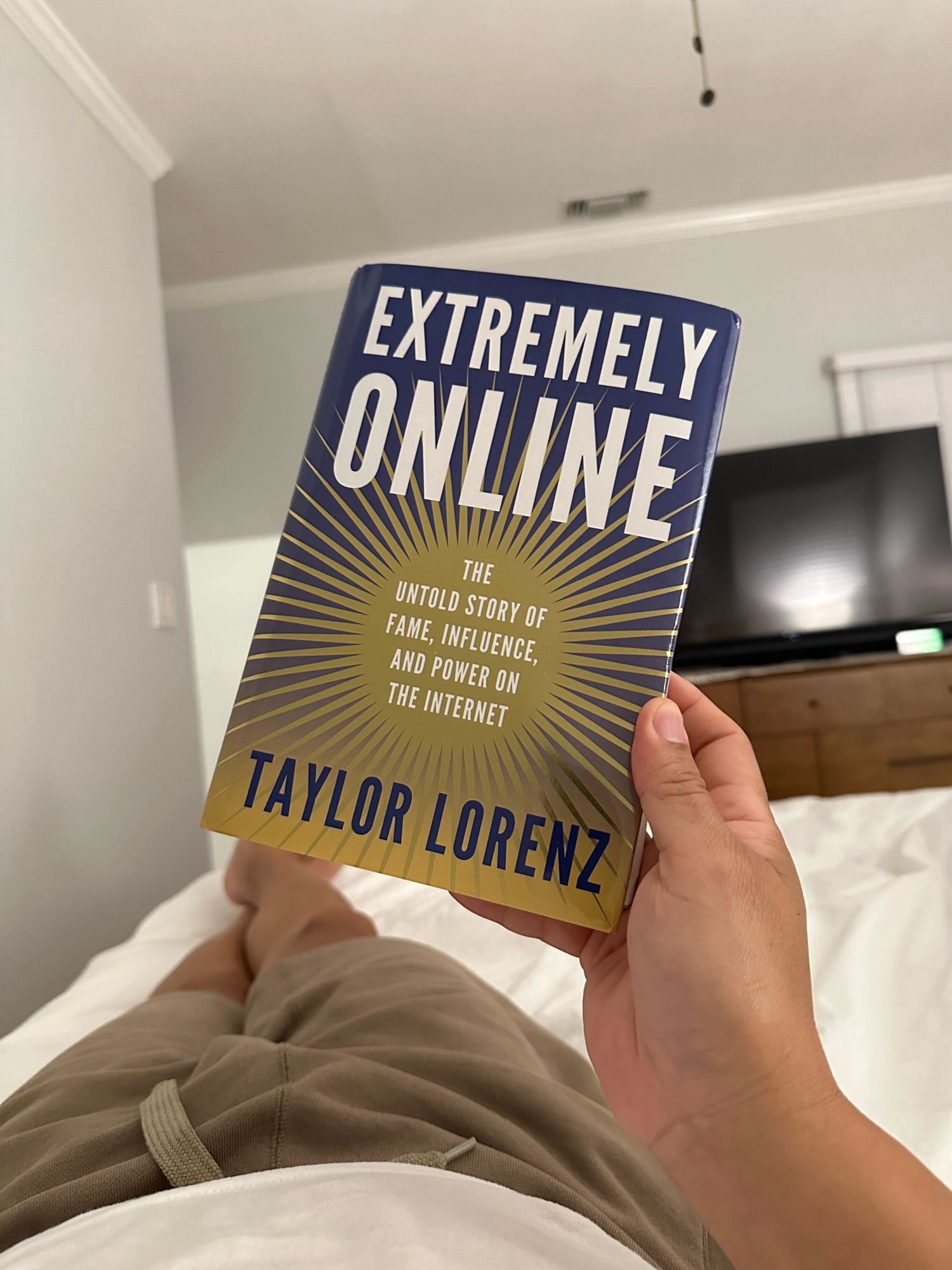 Holding up a book: “Extremely Online” by Taylor Lorenz