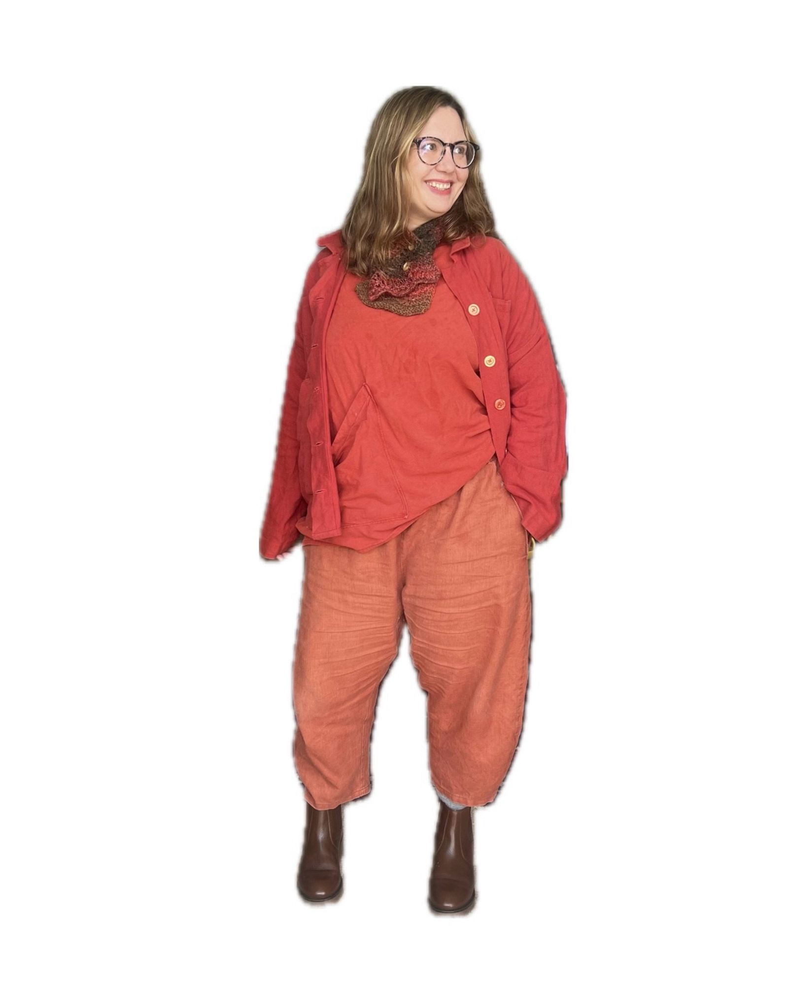 An image of a short slightly chubby woman recreating the pose in an all red outfit (scarf, jacket, top, trousers)